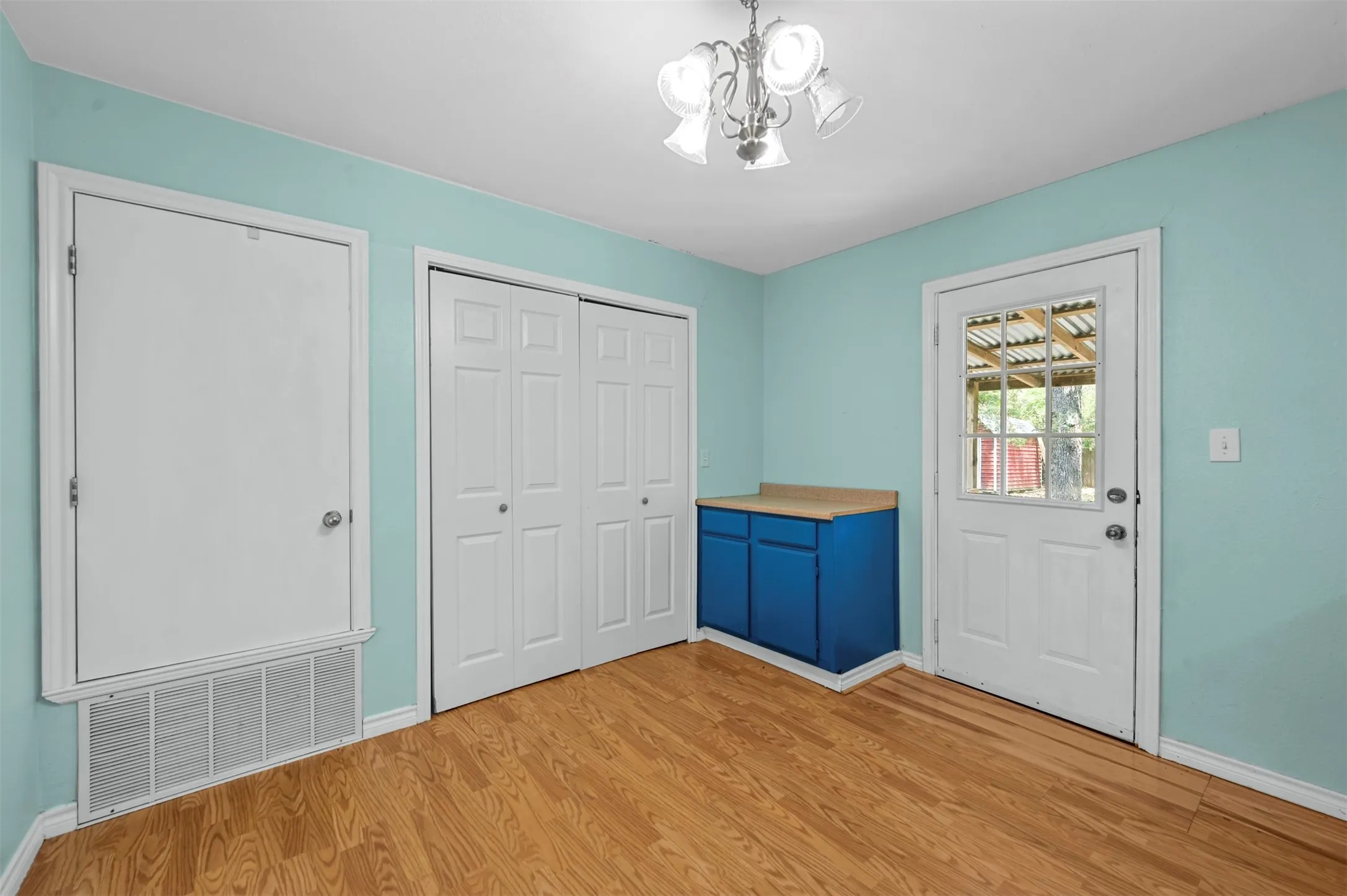Entryway with a notable chandelier and light hardwood / wood-style flooring