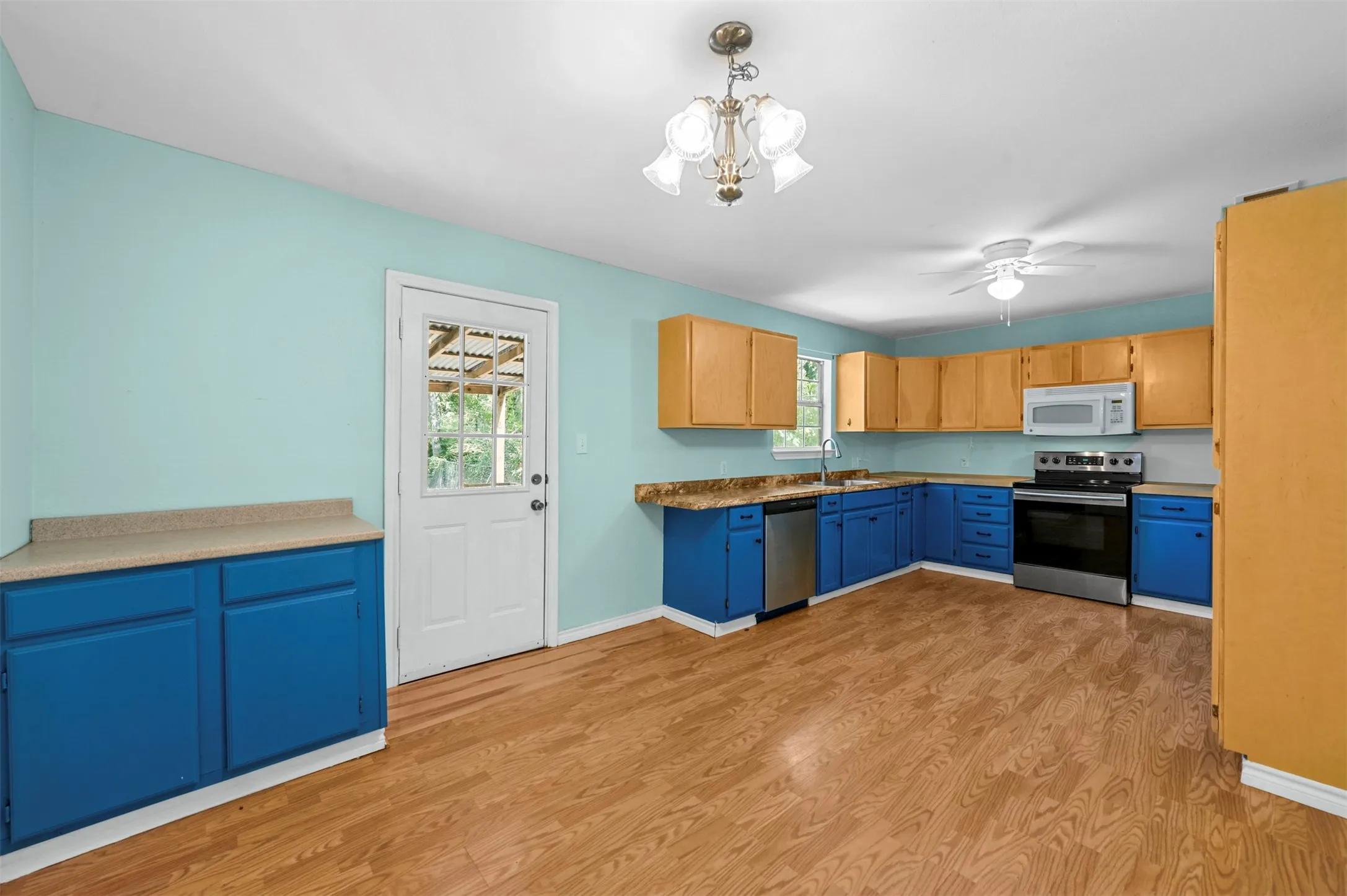 Kitchen featuring light hardwood / wood-style flooring, appliances with stainless steel finishes, and a wealth of natural light