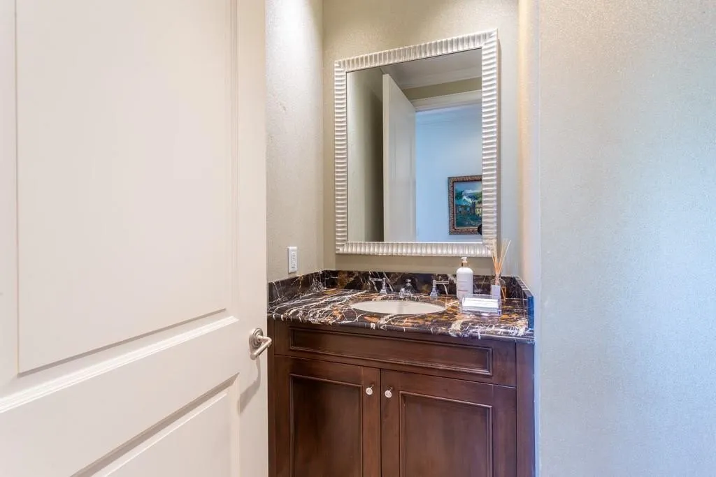 Powder Room boasts Imperial Brown marble counters & Crema Marfil inlaid floor.