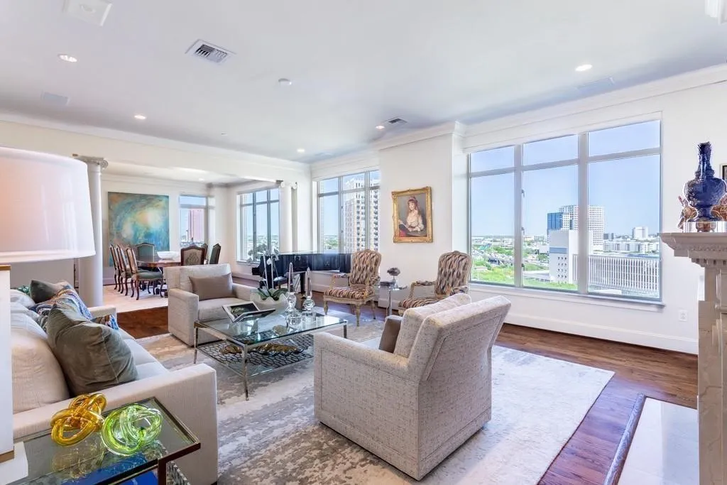 Gracious Living Room has hardwood floors, 10' ceilings, operable windows & an expansive view.
