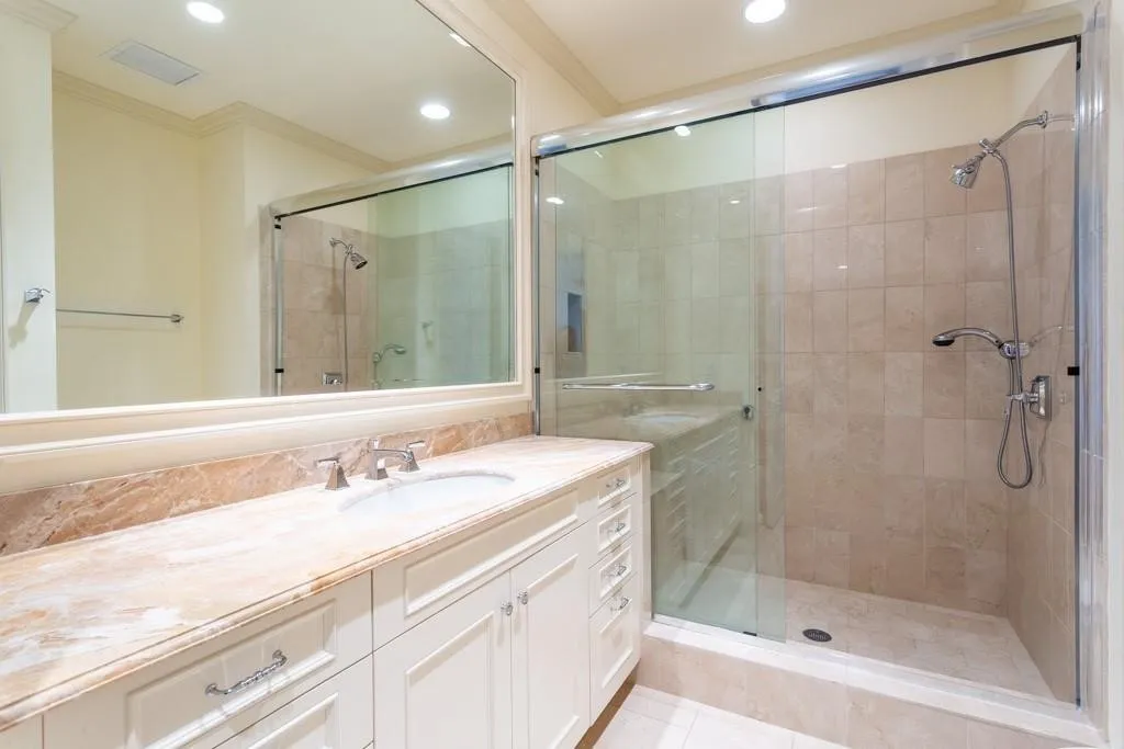 Ensuite Guest Bath has Crema Marfil and Breccia Oniciatta marble