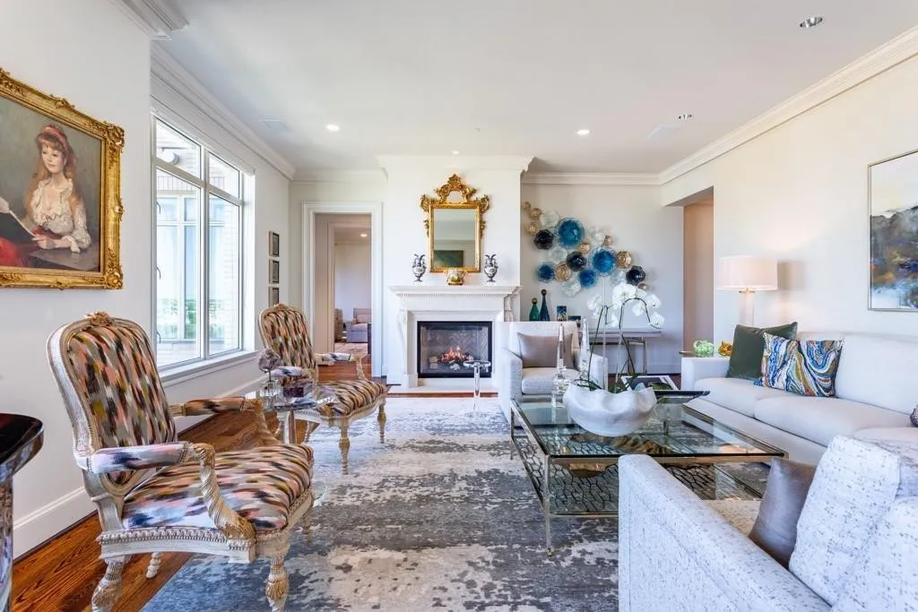 Marble fireplace, flanked by entry and entrance to Guest Suite.