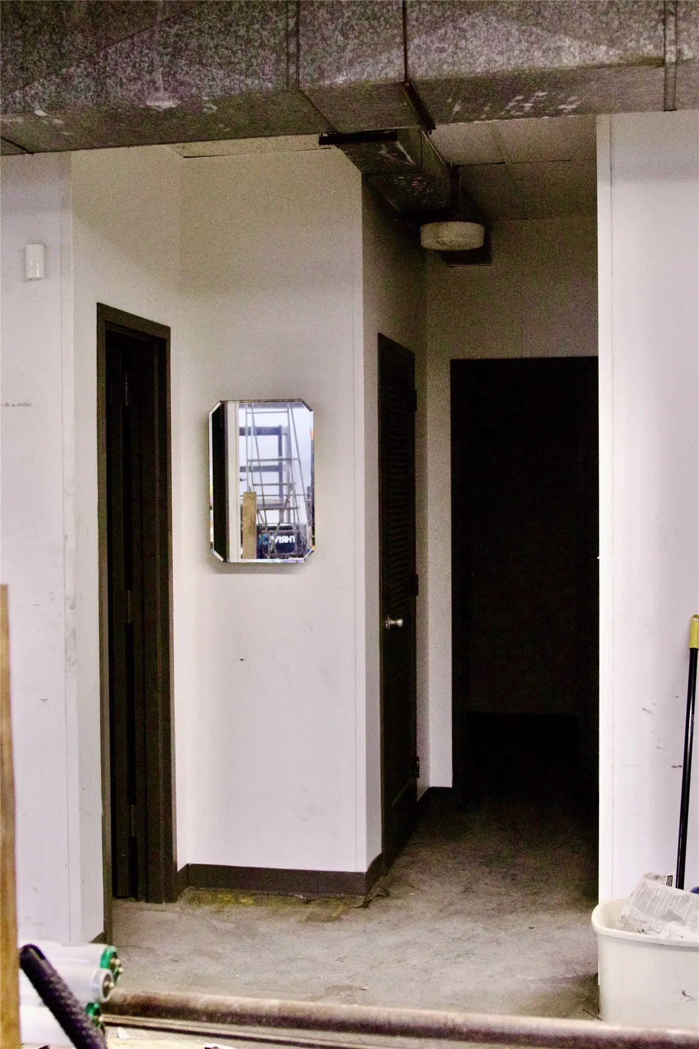 The property features exposed ceiling ductwork and a concrete floor