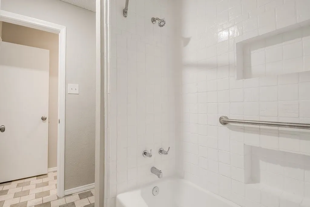 Jack and Jill Restroom with a white tiled shower and a built-in shower niche