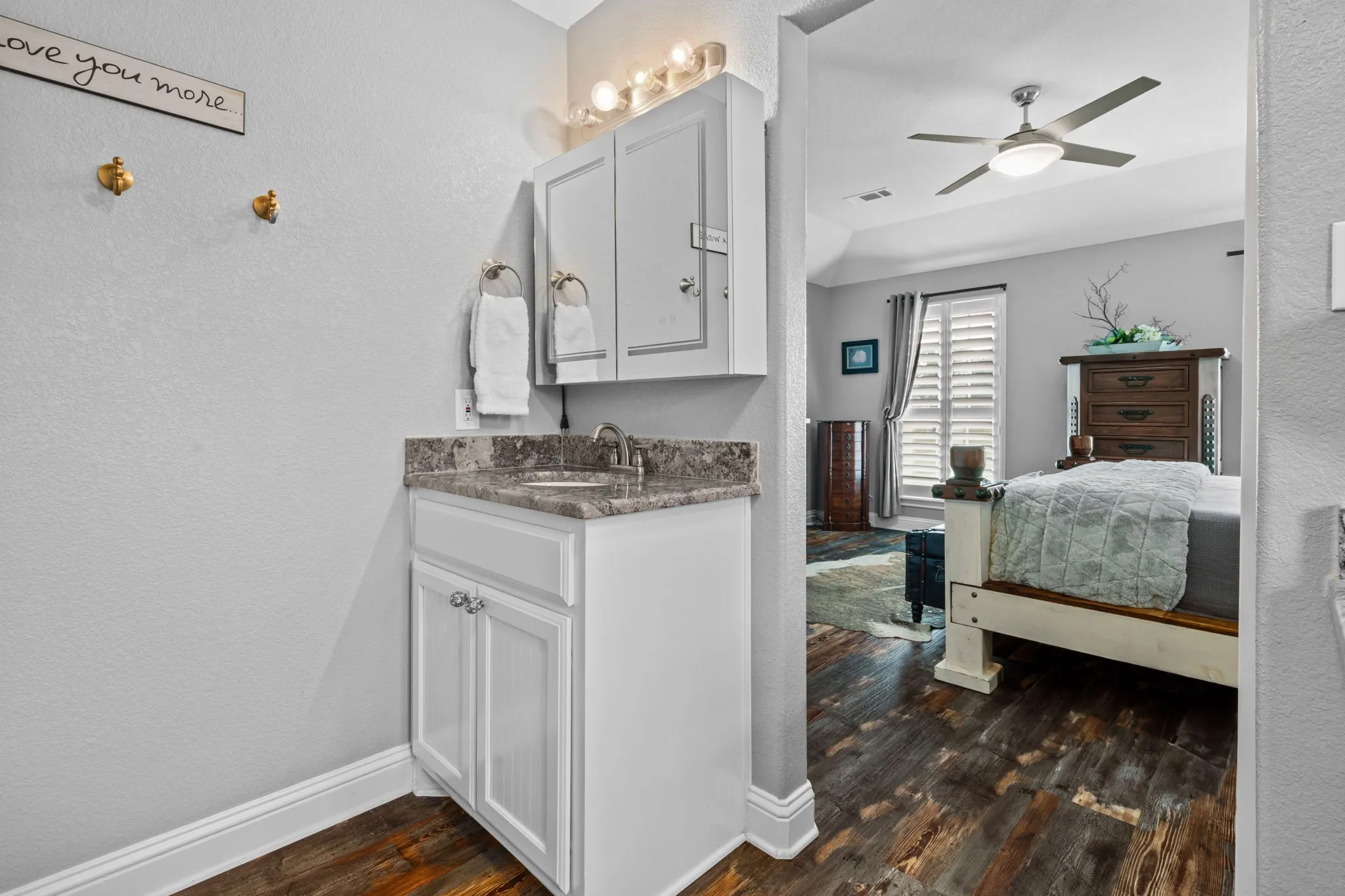 The second granite vanity enhances the ensuite with added functionality, elegant finishes, and beautifully updated lighting.