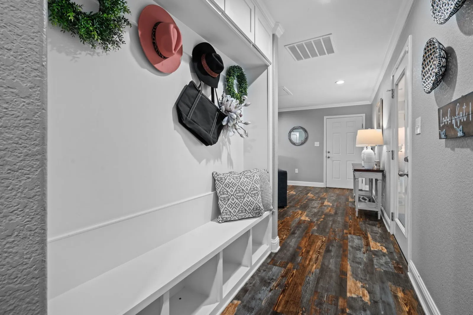 The entrance is flanked by an office with French doors & spacious dining with built-ins. Plantation shutters & farmhouse-inspired luxury vinyl floors add charm & elegance.