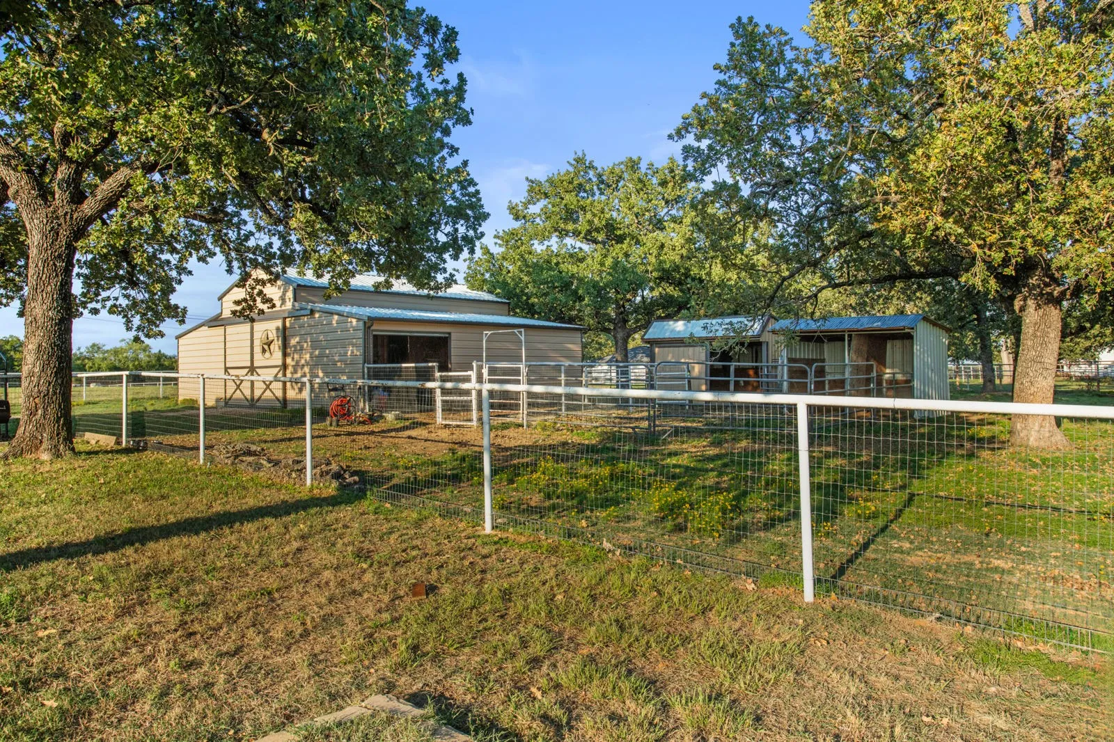Land is fully pipe fenced & features a 31x40 barn with 4 stalls, 1 outfitted for animals. Loafing shed with power & heat & spring-fed pond.