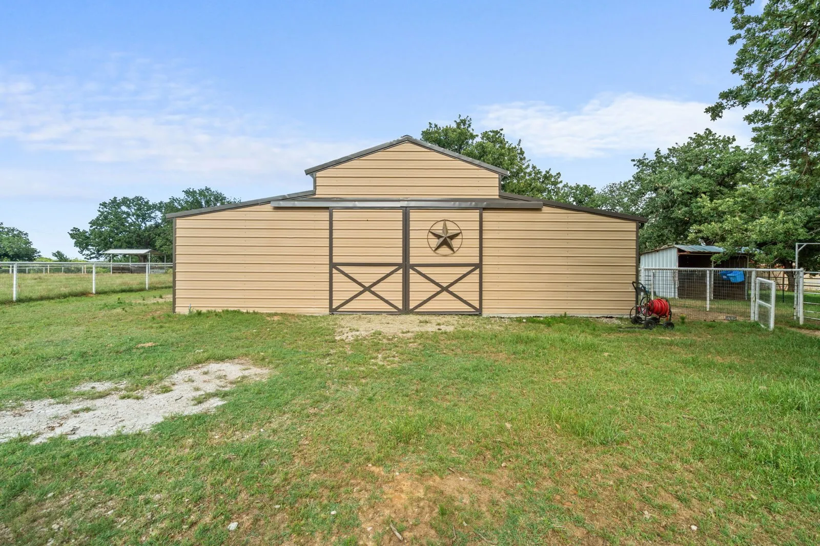 Barn includes full electric, 220 outlet, stained concrete floors, 18 ft. overhead door & drive-through access for vehicles 30ft. long & 18ft. high.