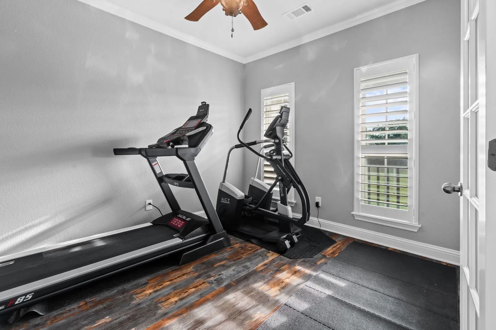Currently set up as a home gym, this versatile room also makes a peaceful, light-filled office with French doors and serene views.