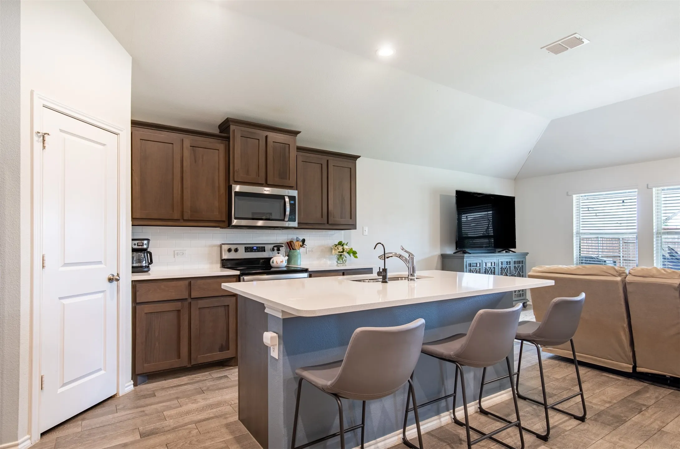 Eat-in kitchen with island and walk in pantry.
