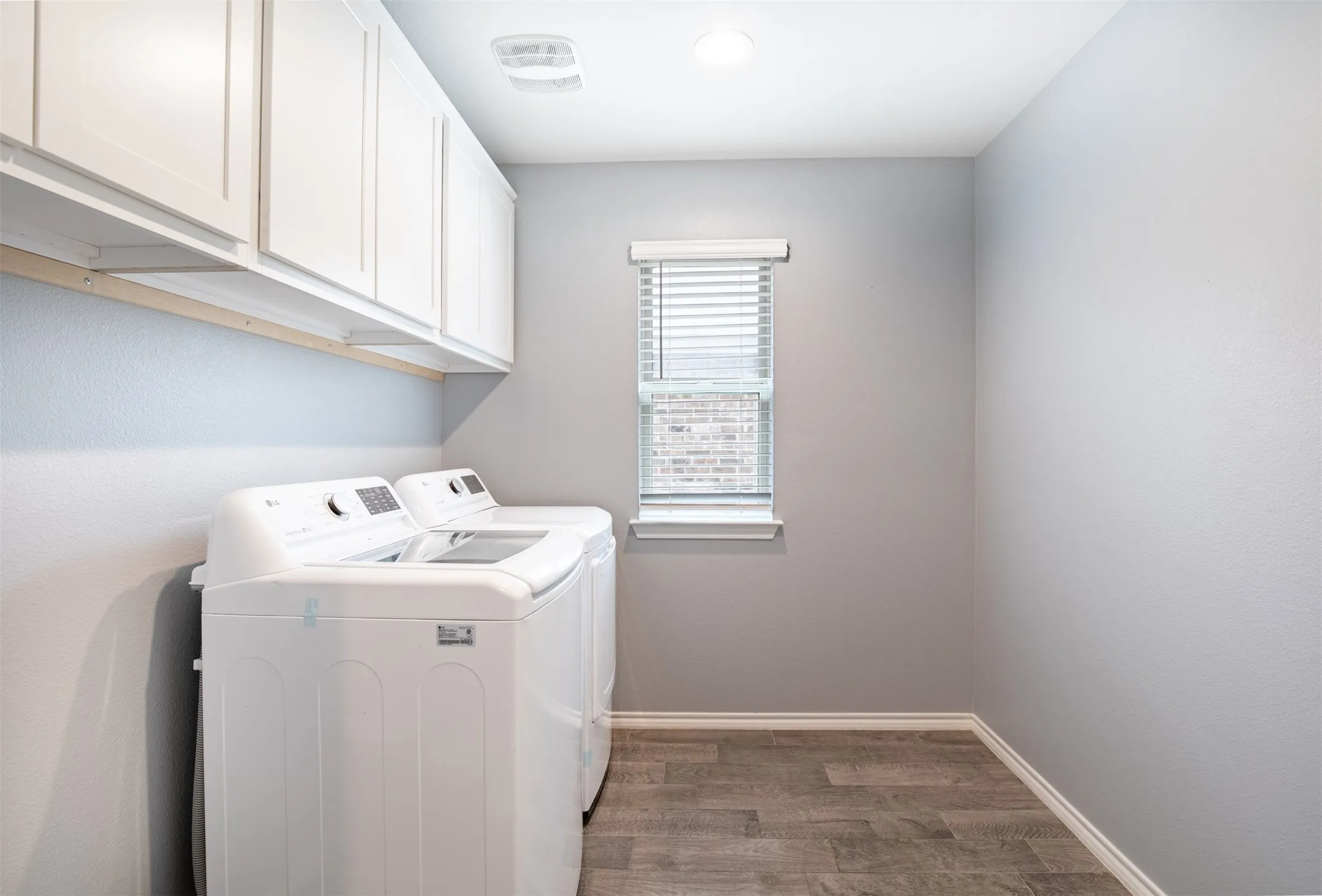 Spacious laundry room with cabinet storage