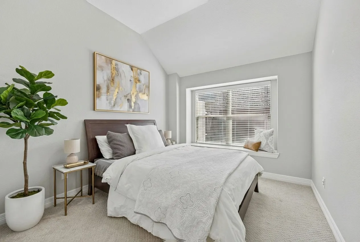 Comfortable guest space with natural light and a soft neutral palette.
