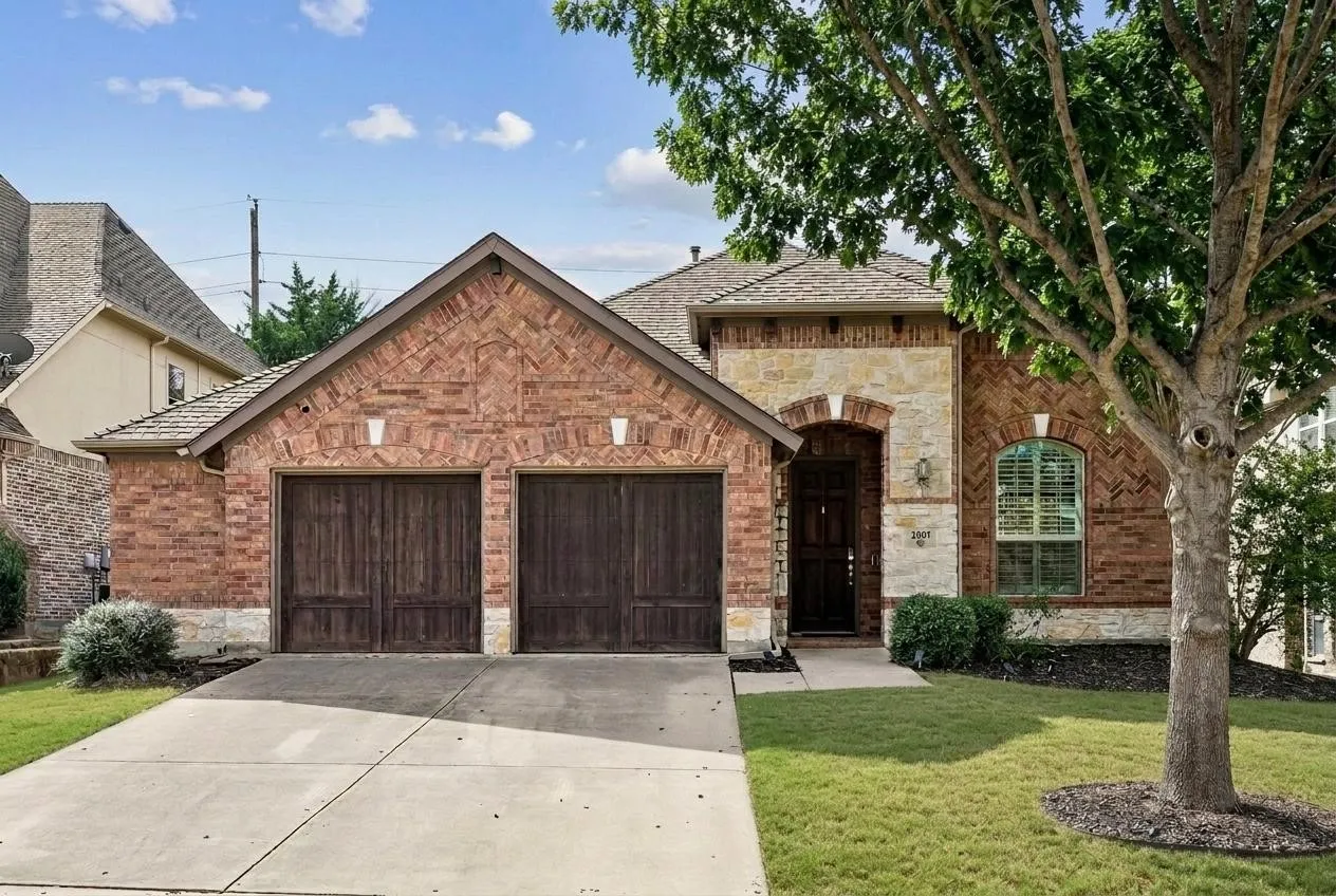 Timeless brick and stone curb appeal in Sorrellwood Park, one of McKinney’s beautifully established neighborhoods.