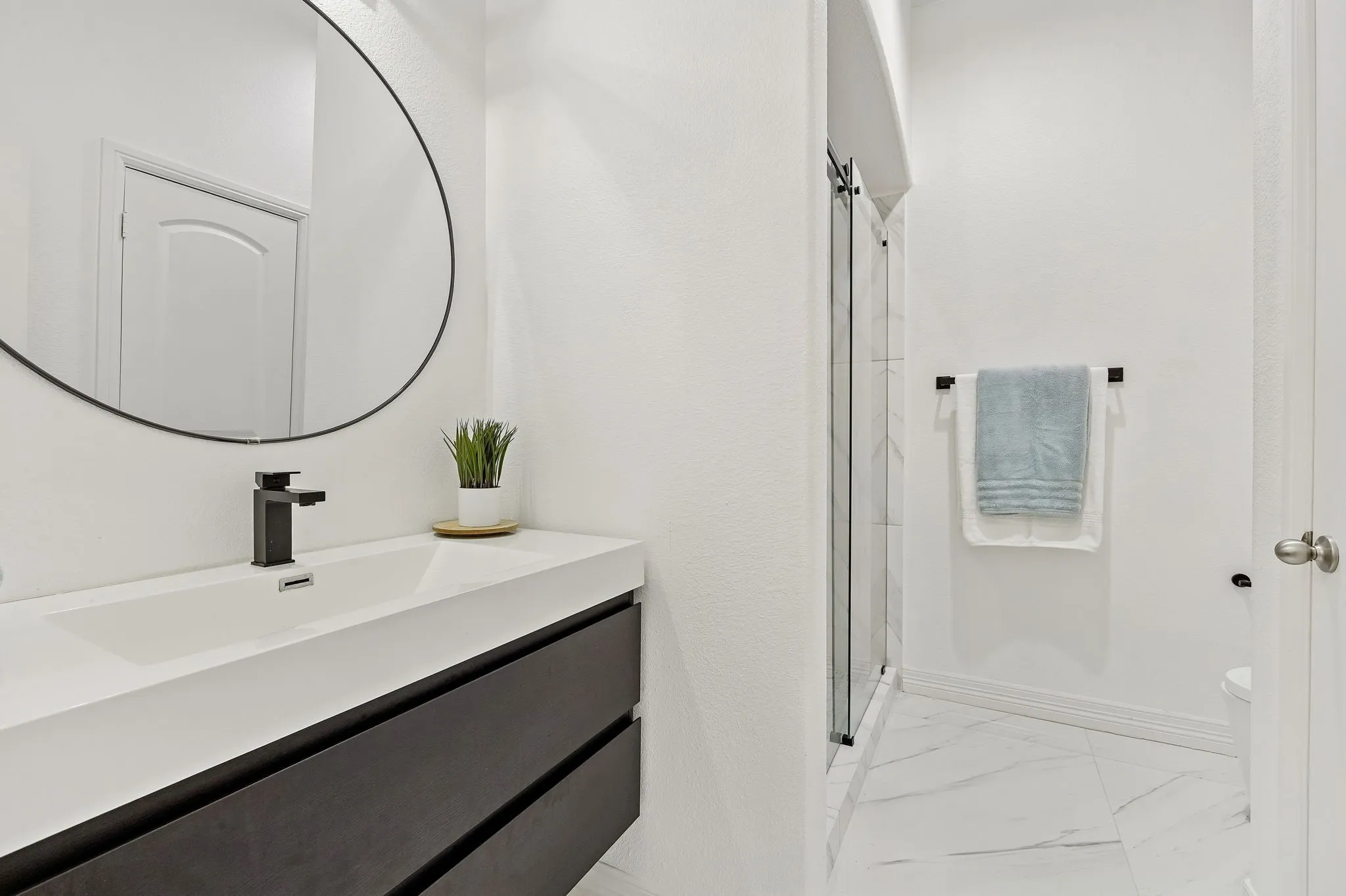 Clean, updated bath finishes continue the modern feel throughout the home.