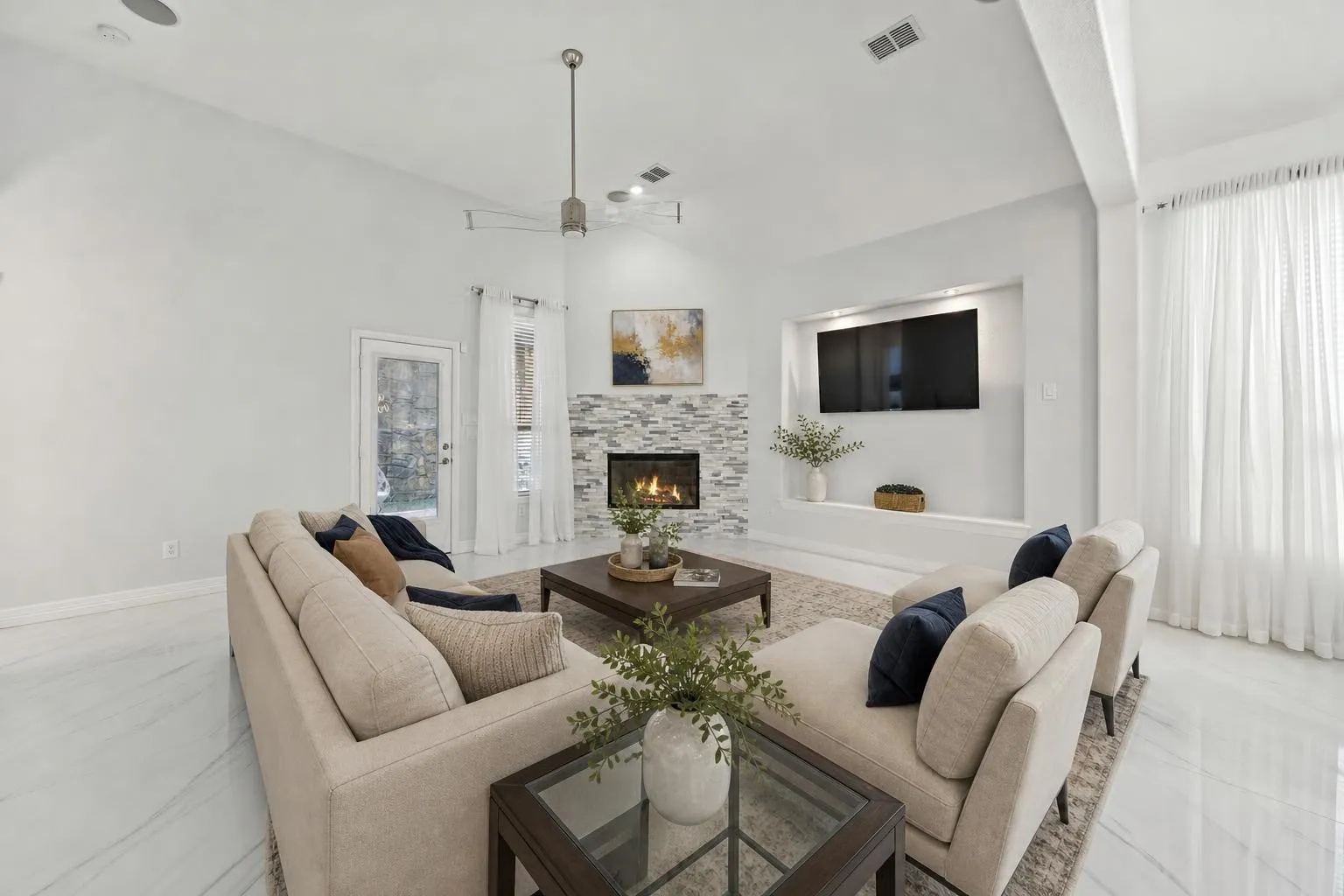 The main living space feels bright, calm, and beautifully updated with a gas fireplace as the focal point.