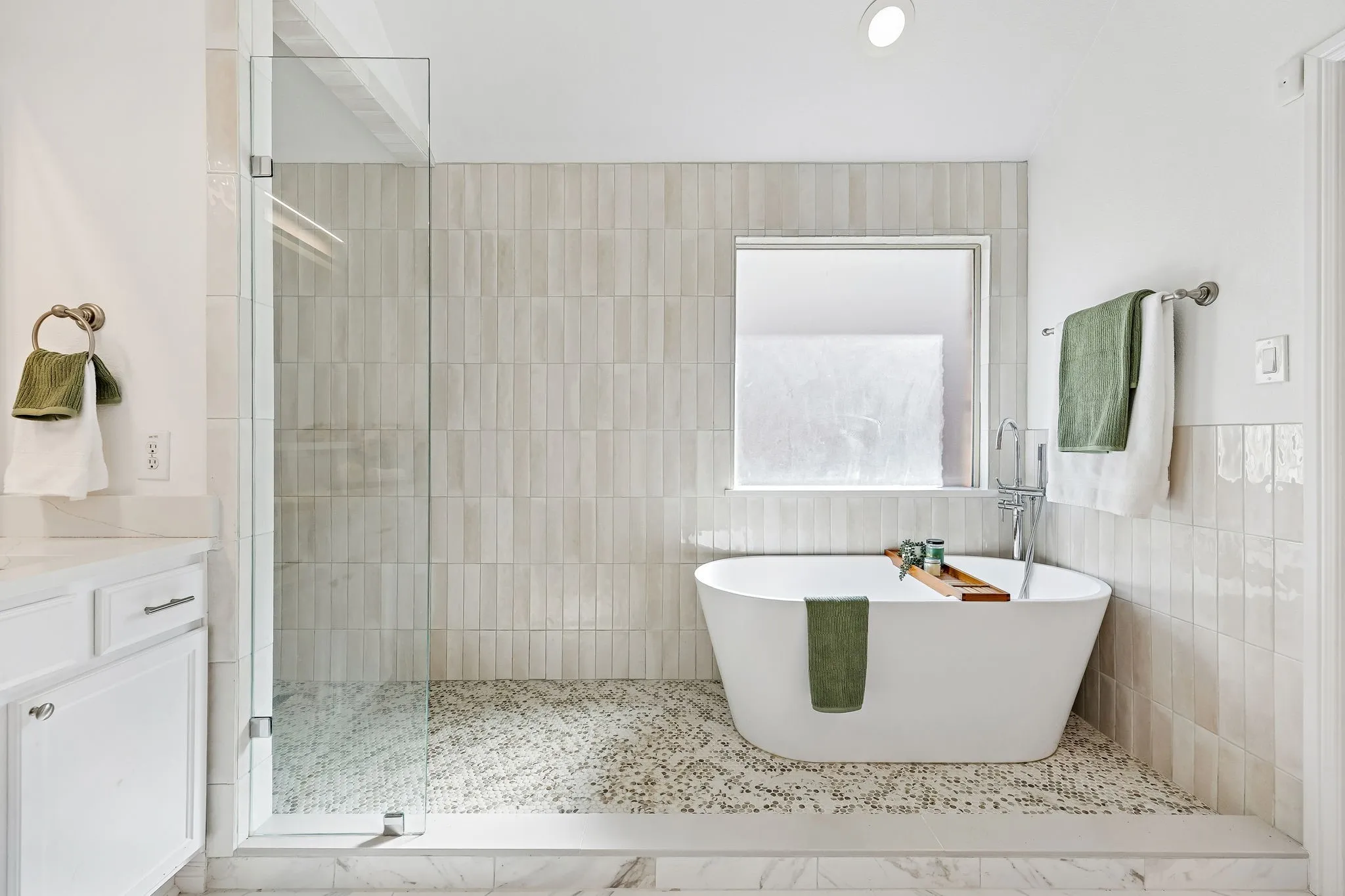 Oversized shower, soaking tub, and soft neutral finishes create a true retreat feel..
