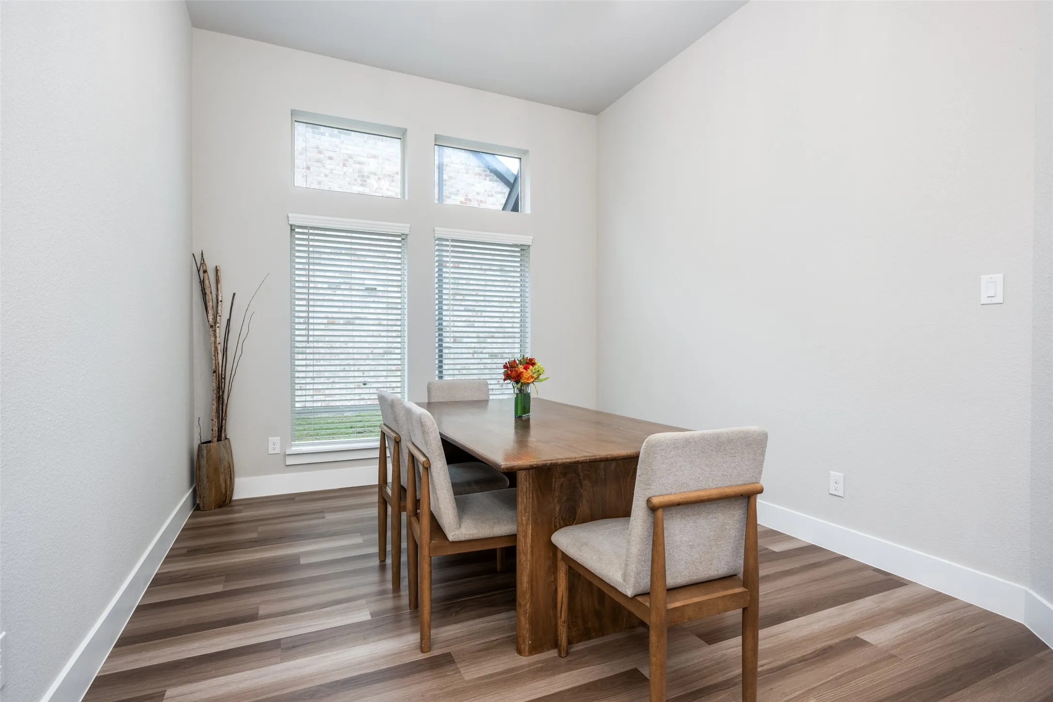 The formal dining is bright and spacious. This table for 8 could easily be replaced with a 12-person table.