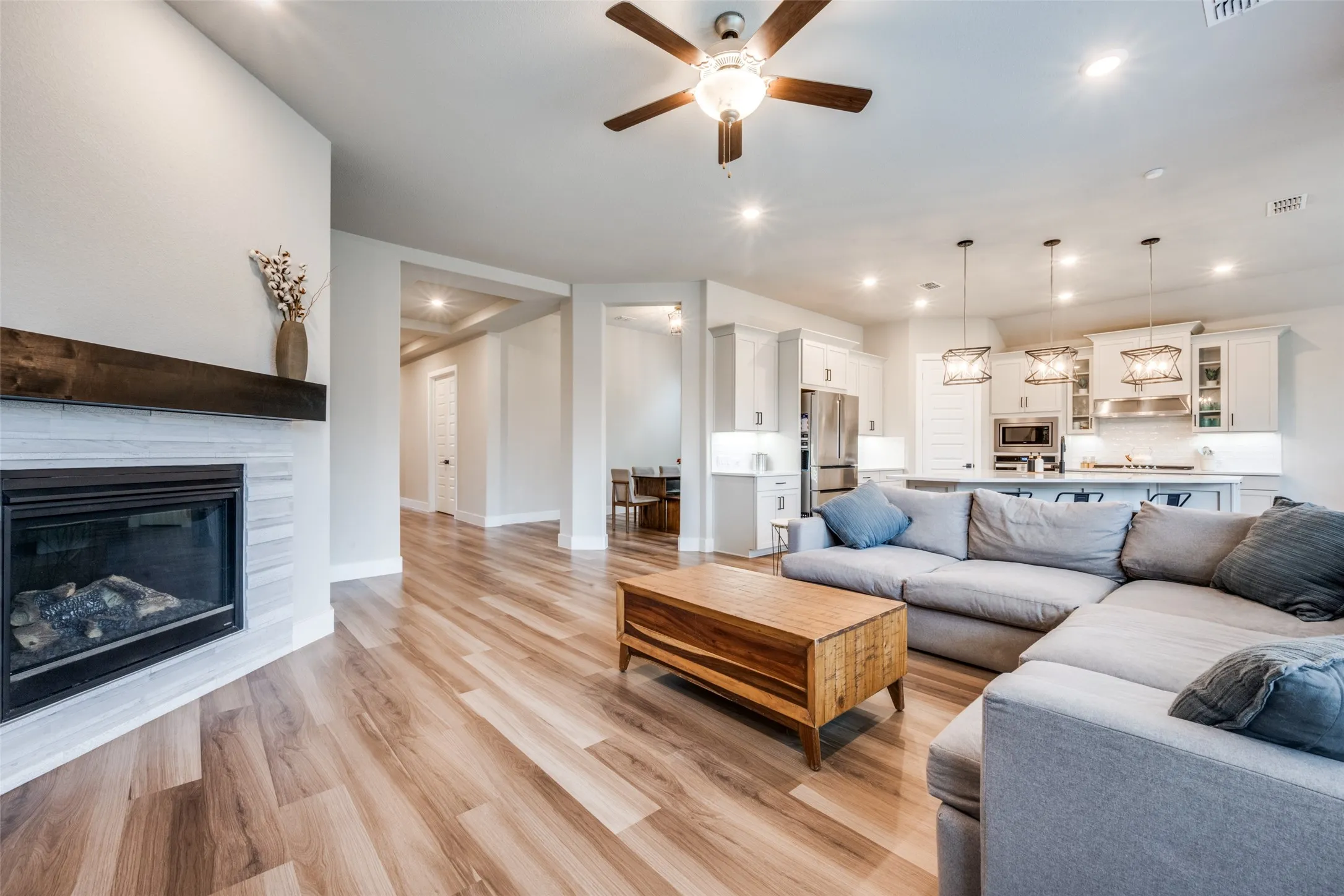 The main living area is spacious, bright, and wide open. Enjoy the gas fireplace and show off your large TV or artwork above the stained wooden mantle.
