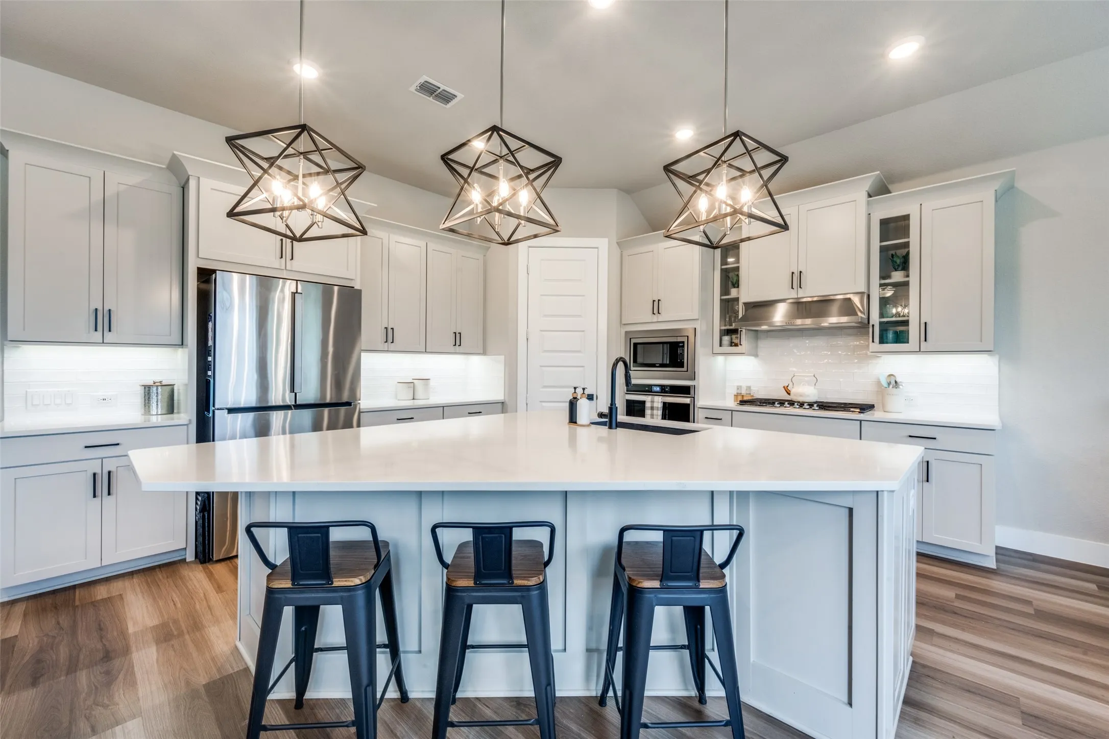 The corner kitchen offers plenty cabinet space and a large island, perfect for serving and entertaining.