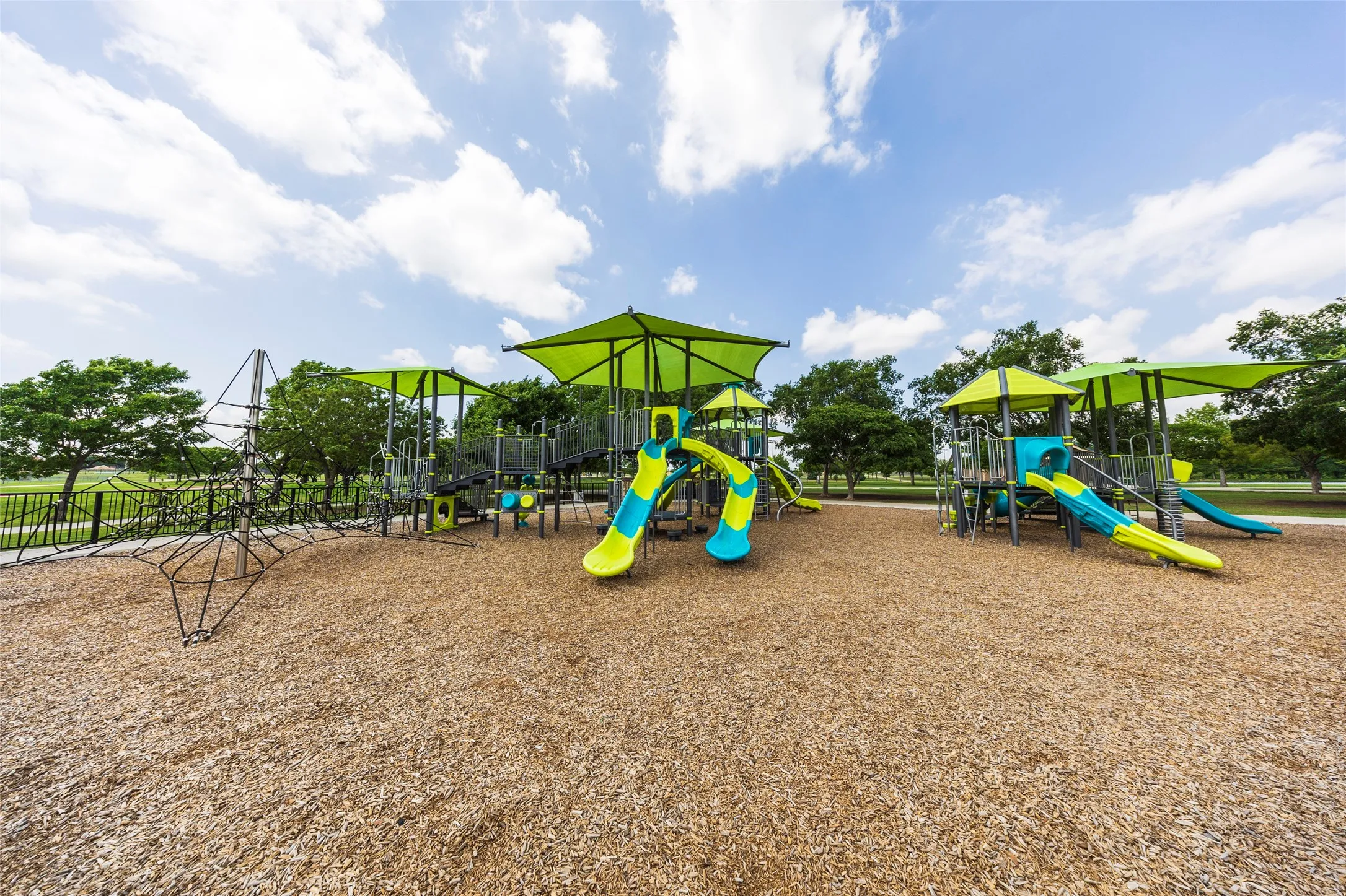 The property features a recreational area with a playground, complete with slides and climbing structures, set on wood chip surfacing