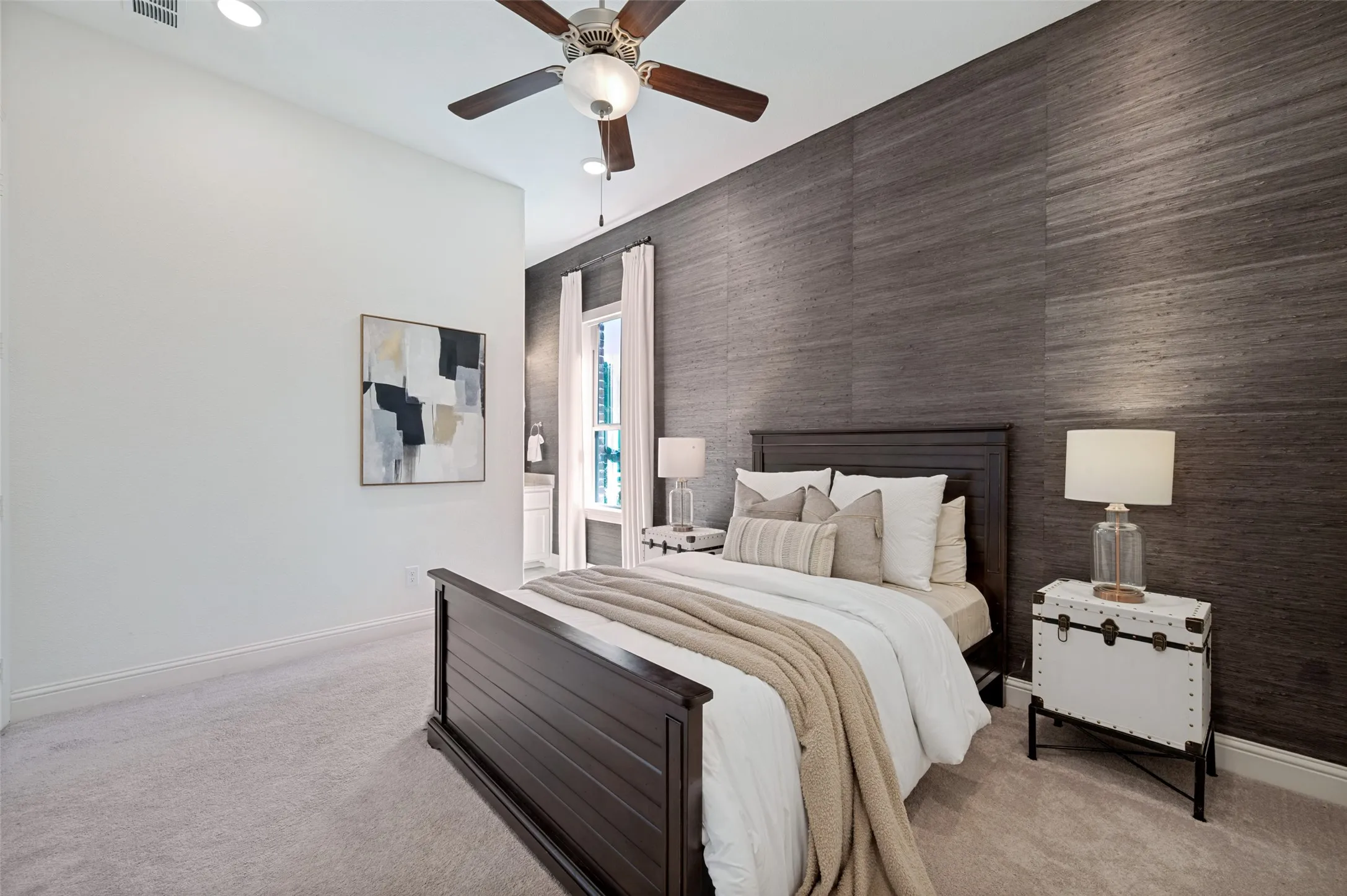 Vaulted ceiling with recessed lighting, ceiling fan, and textured accent wall