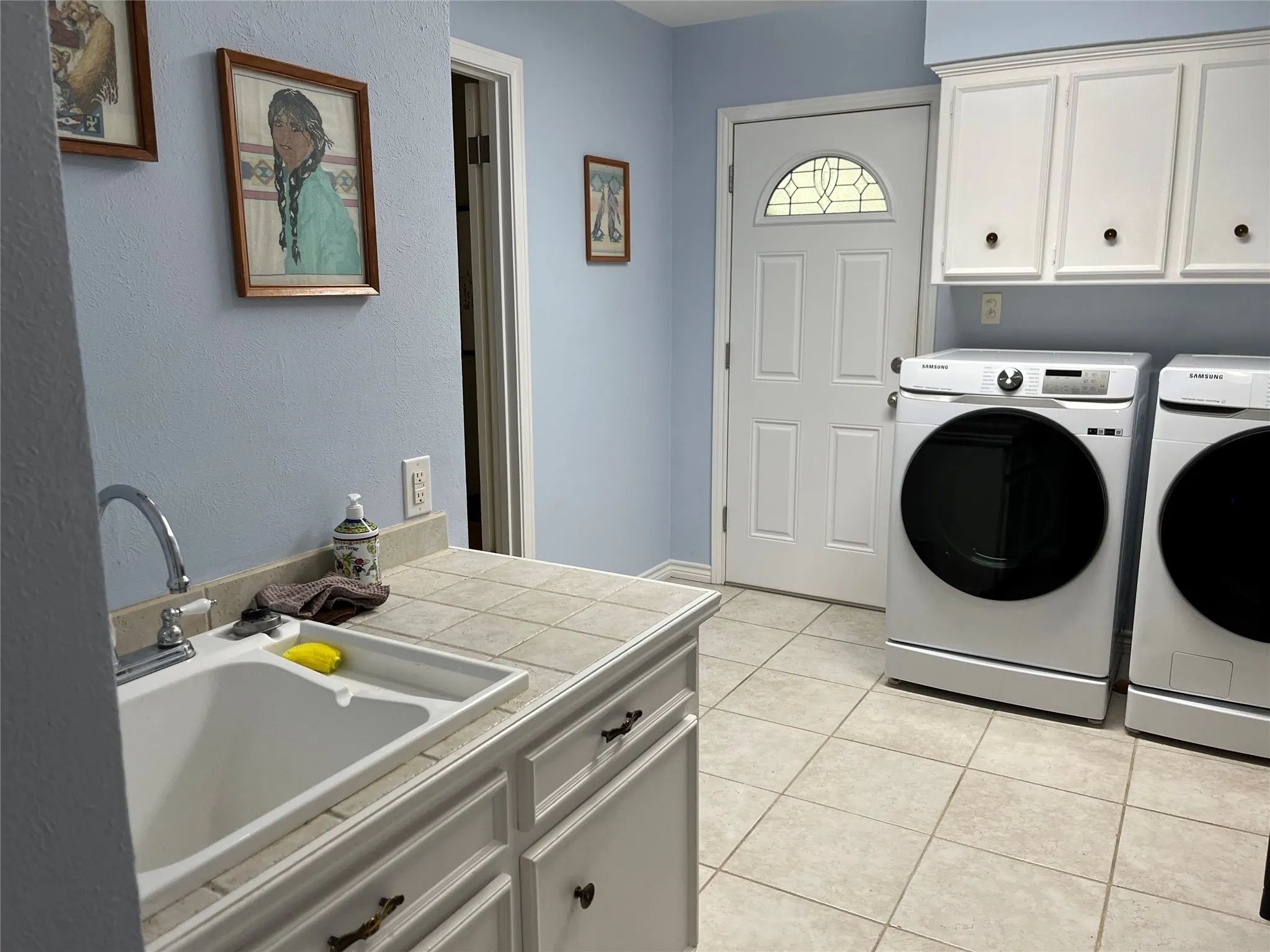 large laundry with sink and walk-in closet
