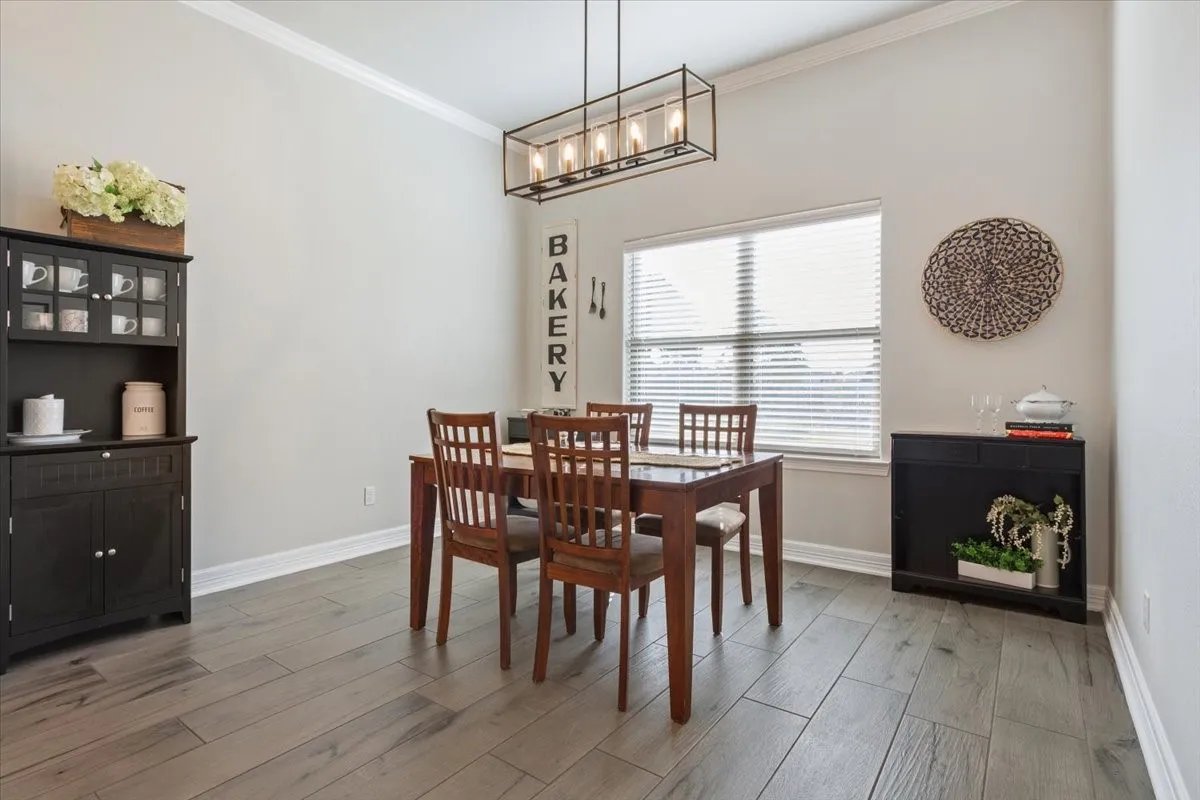 The property features high vaulted ceilings, light-colored walls, and a window with horizontal blinds
