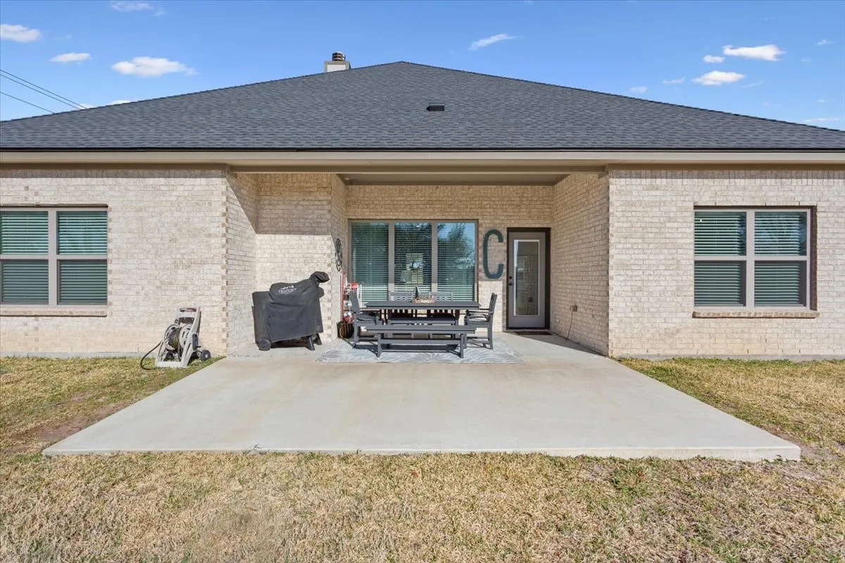 The property features a spacious rear patio and a well-maintained lawn