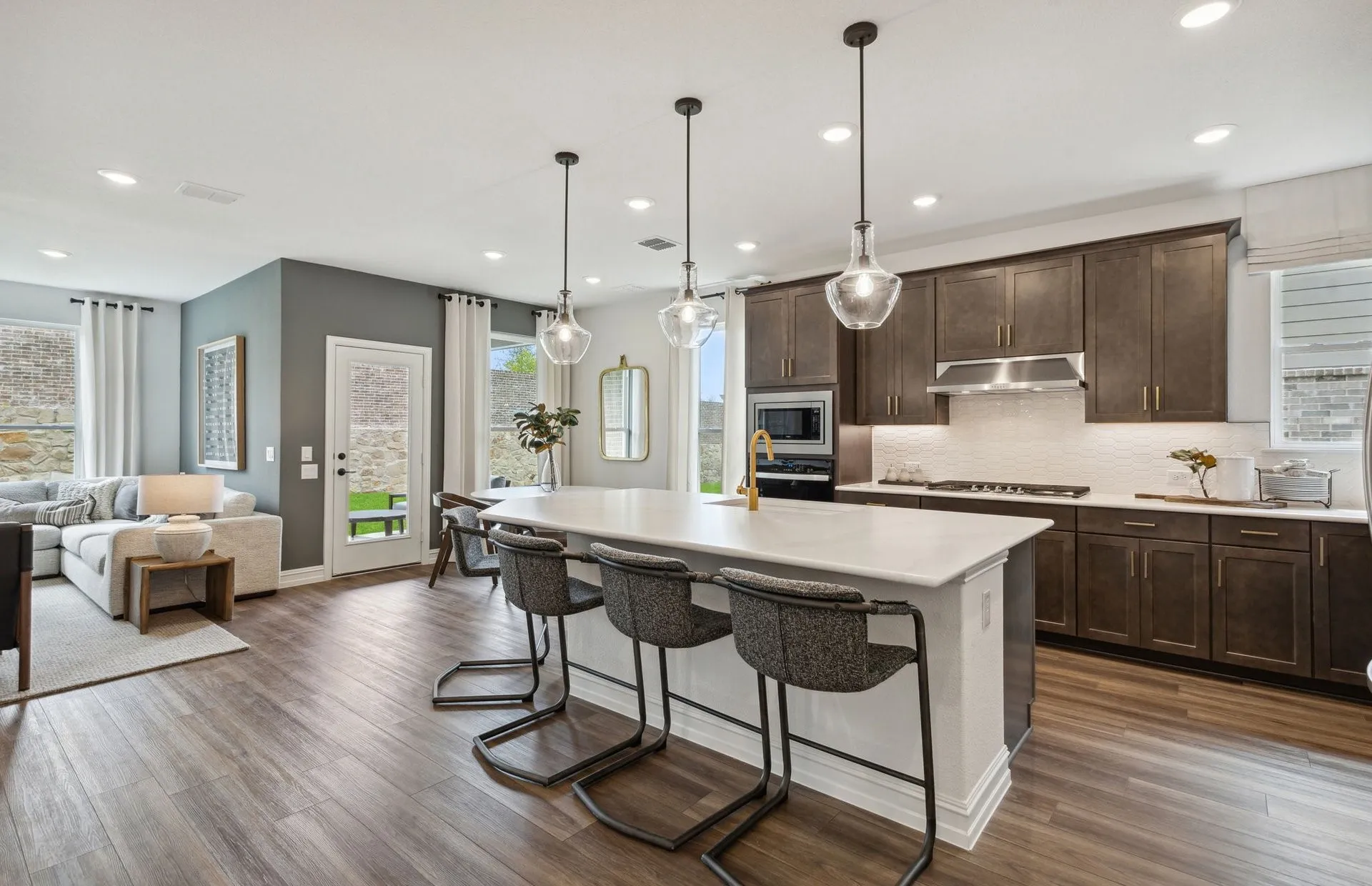 *Model Representation - Large island overlooking gathering room and dining areas