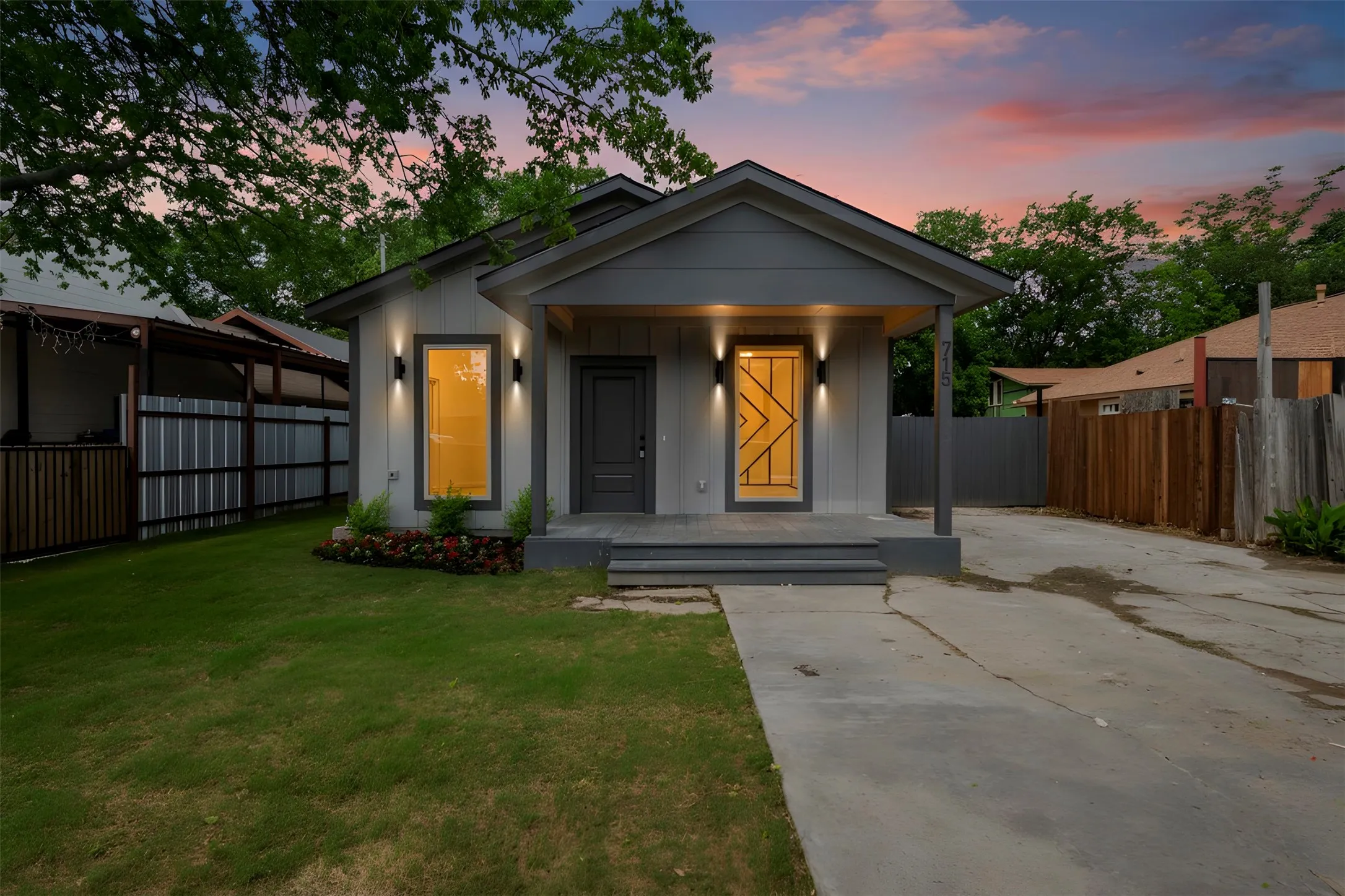 The property features a charming exterior with a light gray facade and a contrasting dark gray trim
