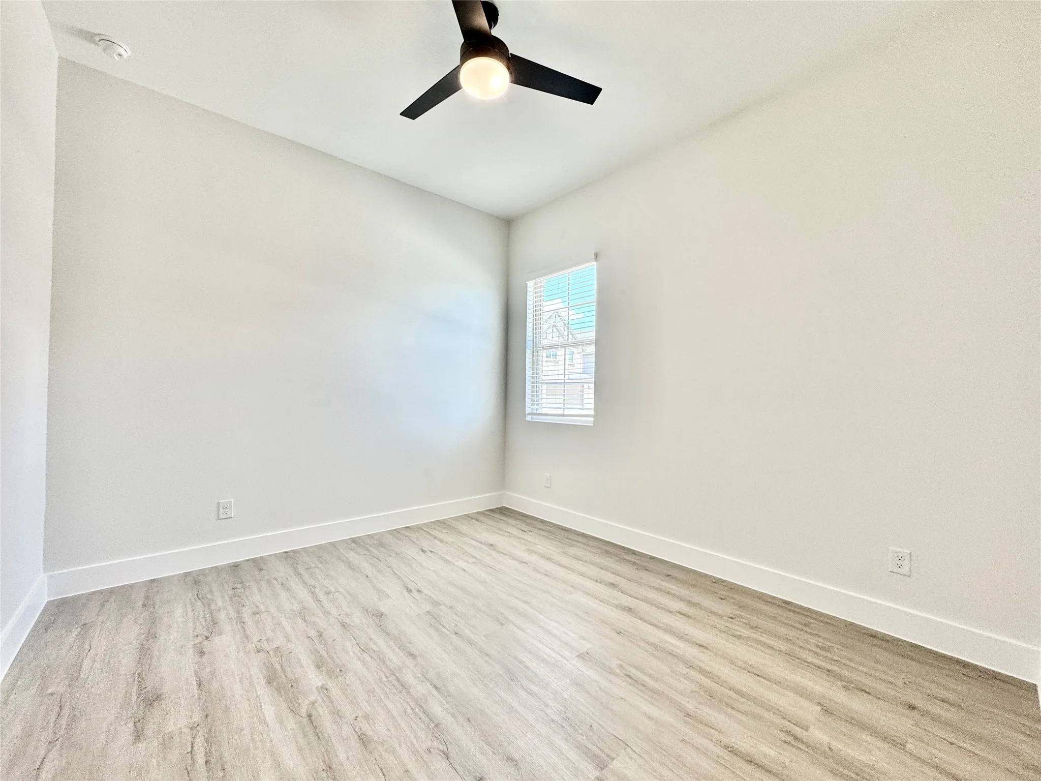 Unfurnished room featuring wood finished floors and baseboards