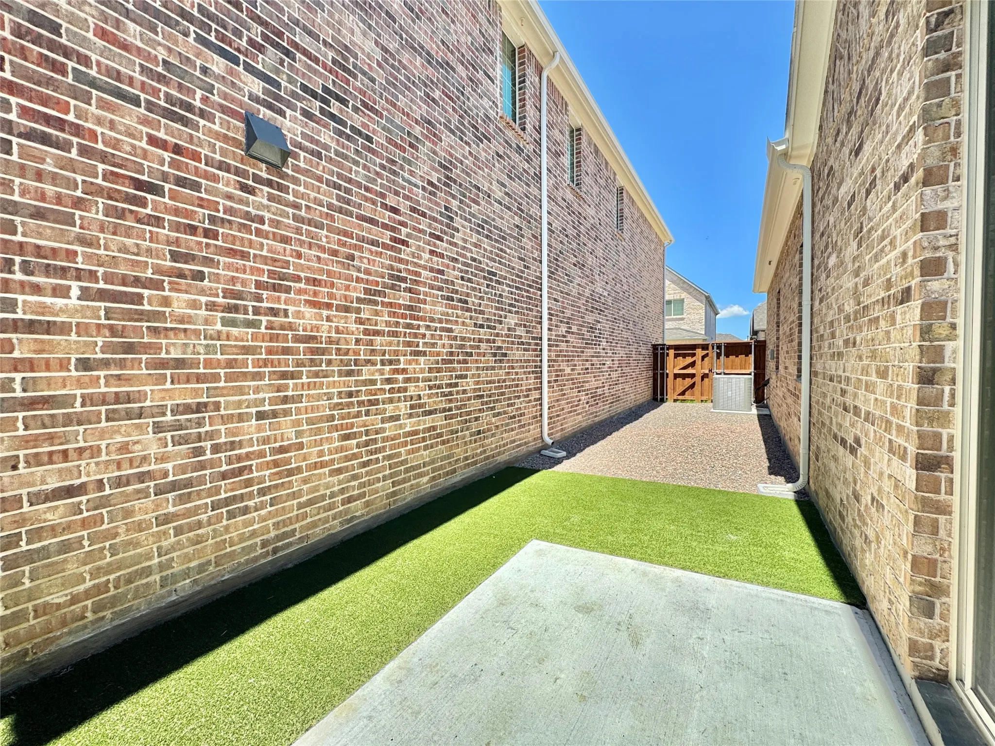 View of yard featuring a patio, fence, and a gate