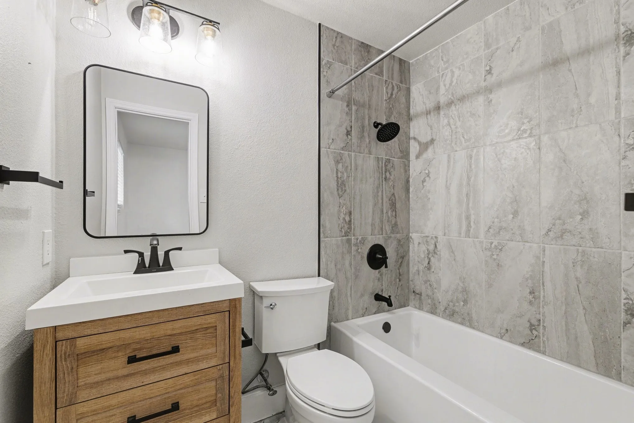 Updated vanity area with wood-look cabinetry and matte black​​‌​​​​‌​​‌‌​‌‌​​​‌‌​‌​‌​‌​​​‌​​ fixtures