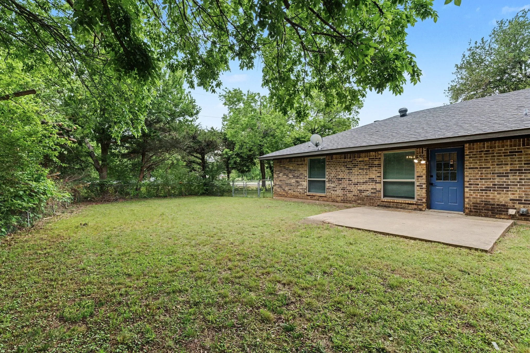 Back patio opens to a spacious lawn for outdoor entertaining