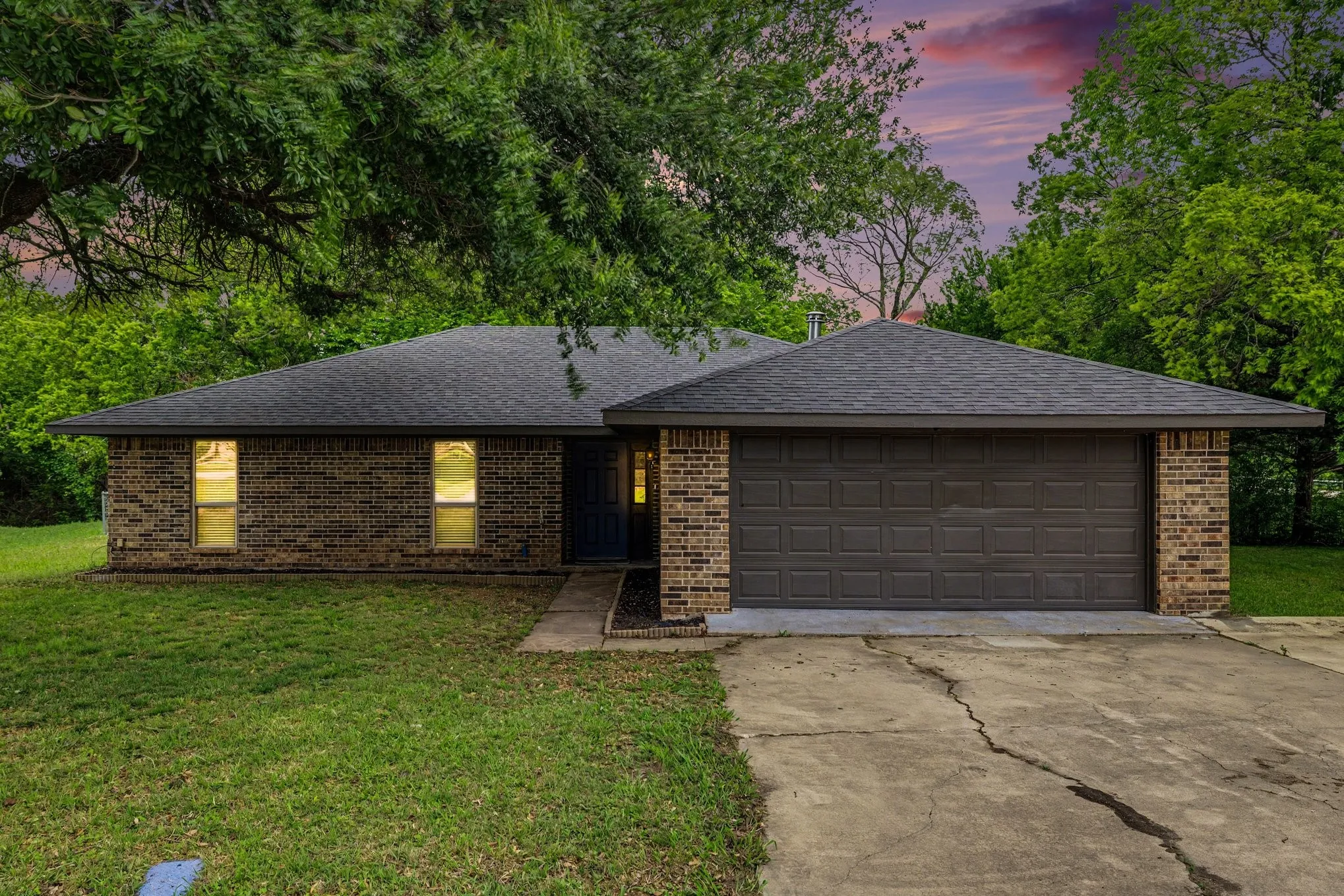 Front elevation with attached garage and landscaped curb appeal
