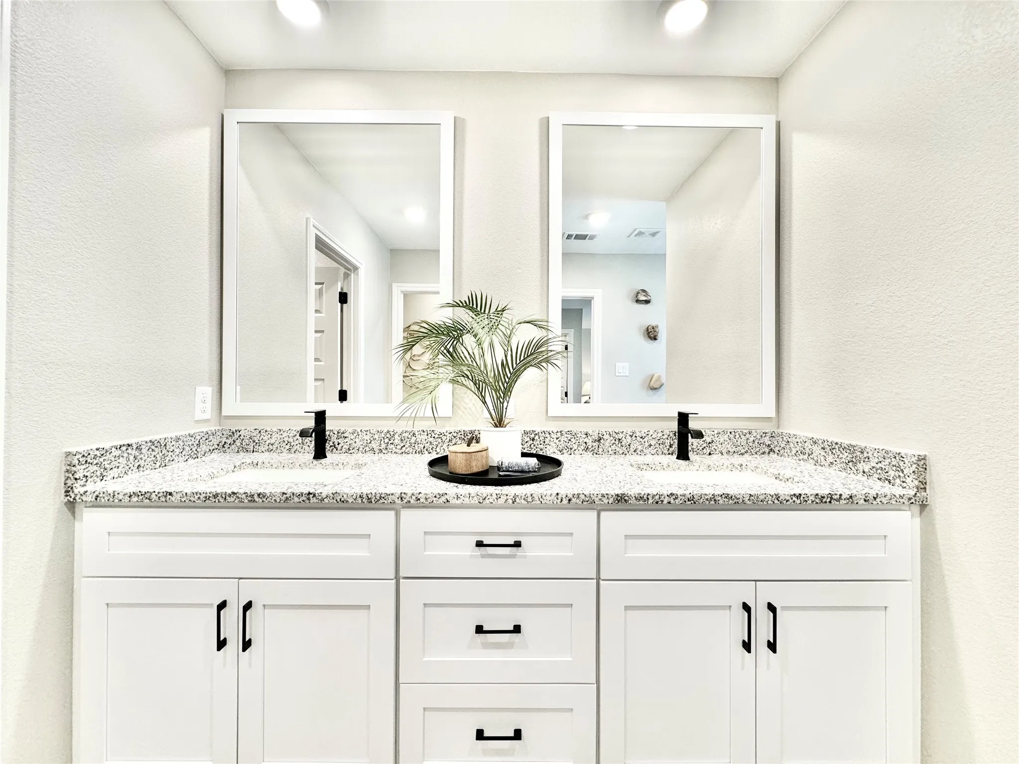 Full bath featuring a sink, double vanity, and visible vents