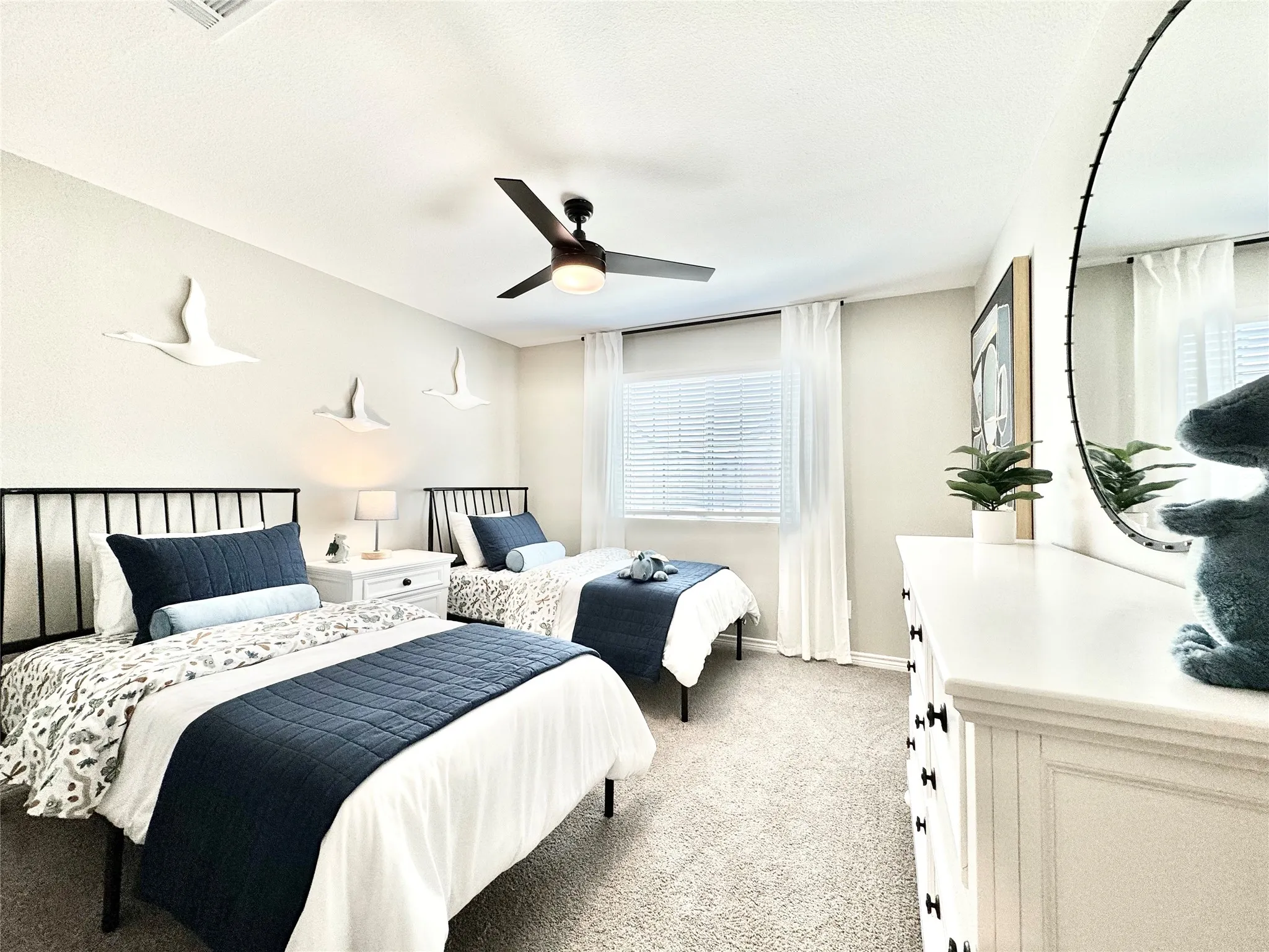 Bedroom with baseboards, ceiling fan, and light colored carpet
