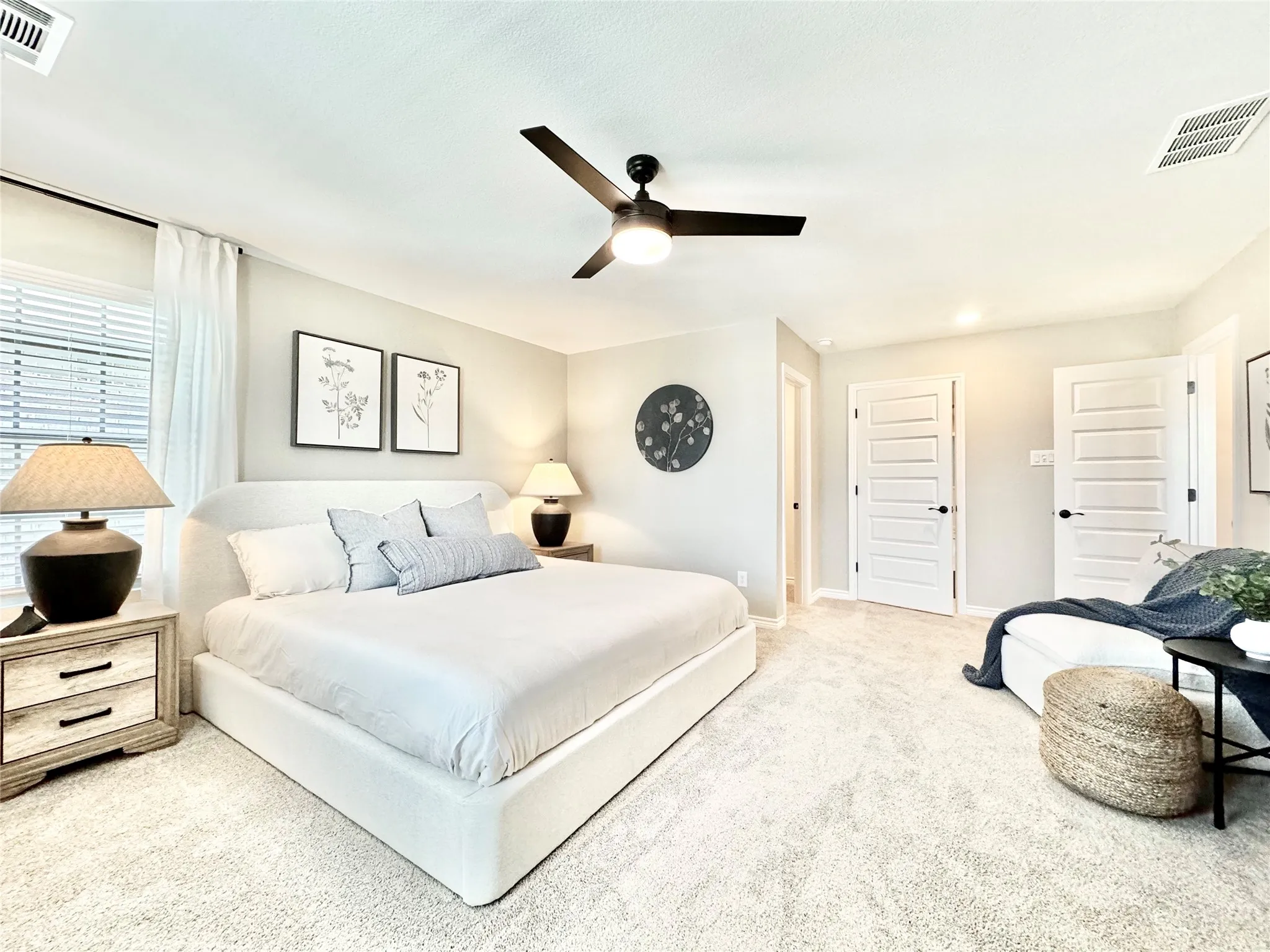 Carpeted bedroom featuring baseboards, ceiling fan, and visible vents