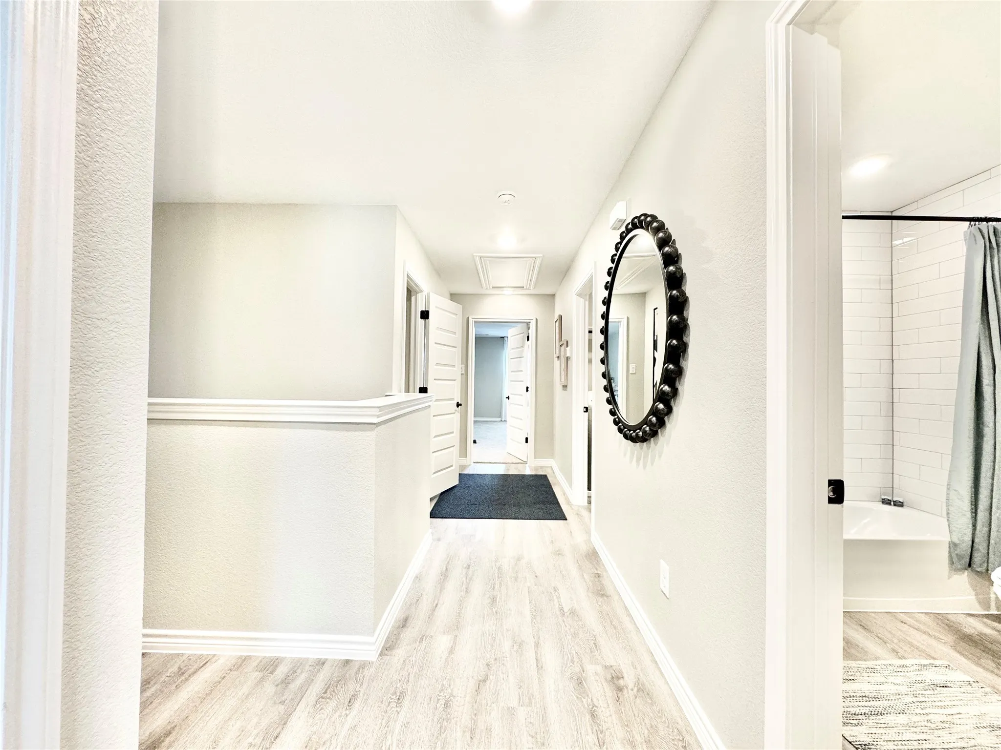 Corridor with baseboards and wood finished floors