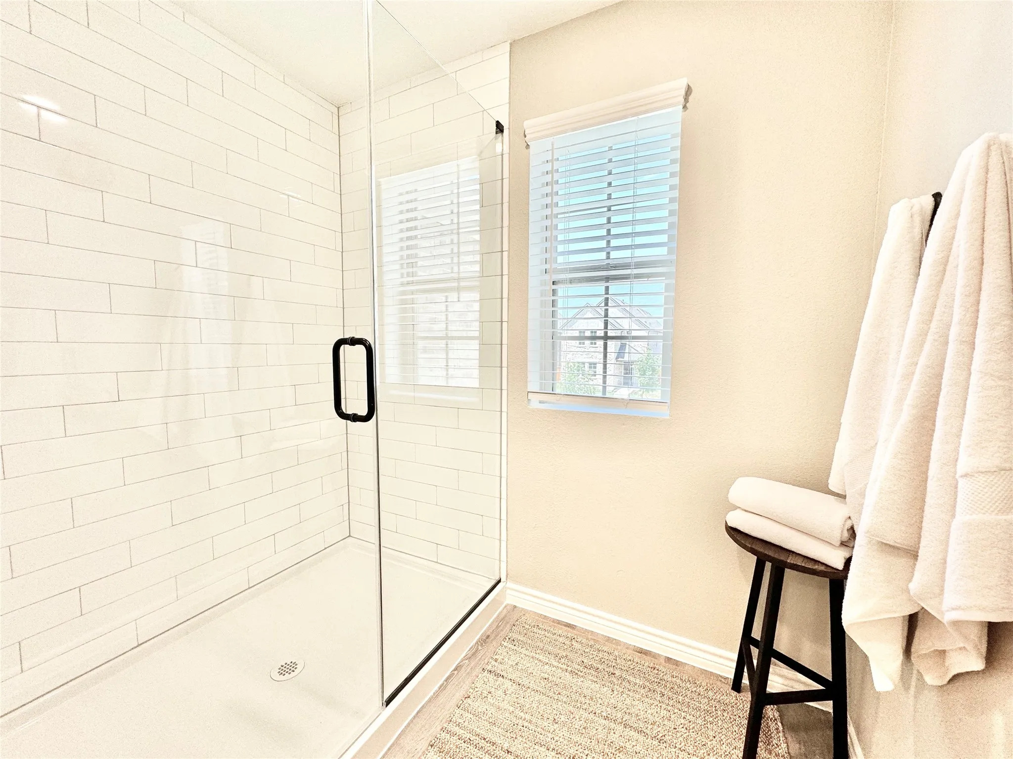 Bathroom featuring a stall shower and baseboards