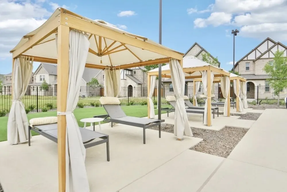 View of property's community with a gazebo, fence, and a patio