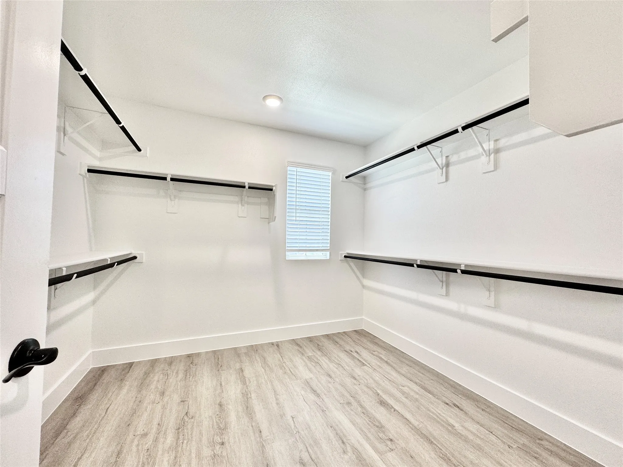 Spacious closet with wood finished floors