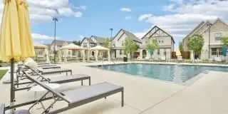 Community pool with a patio and a residential view