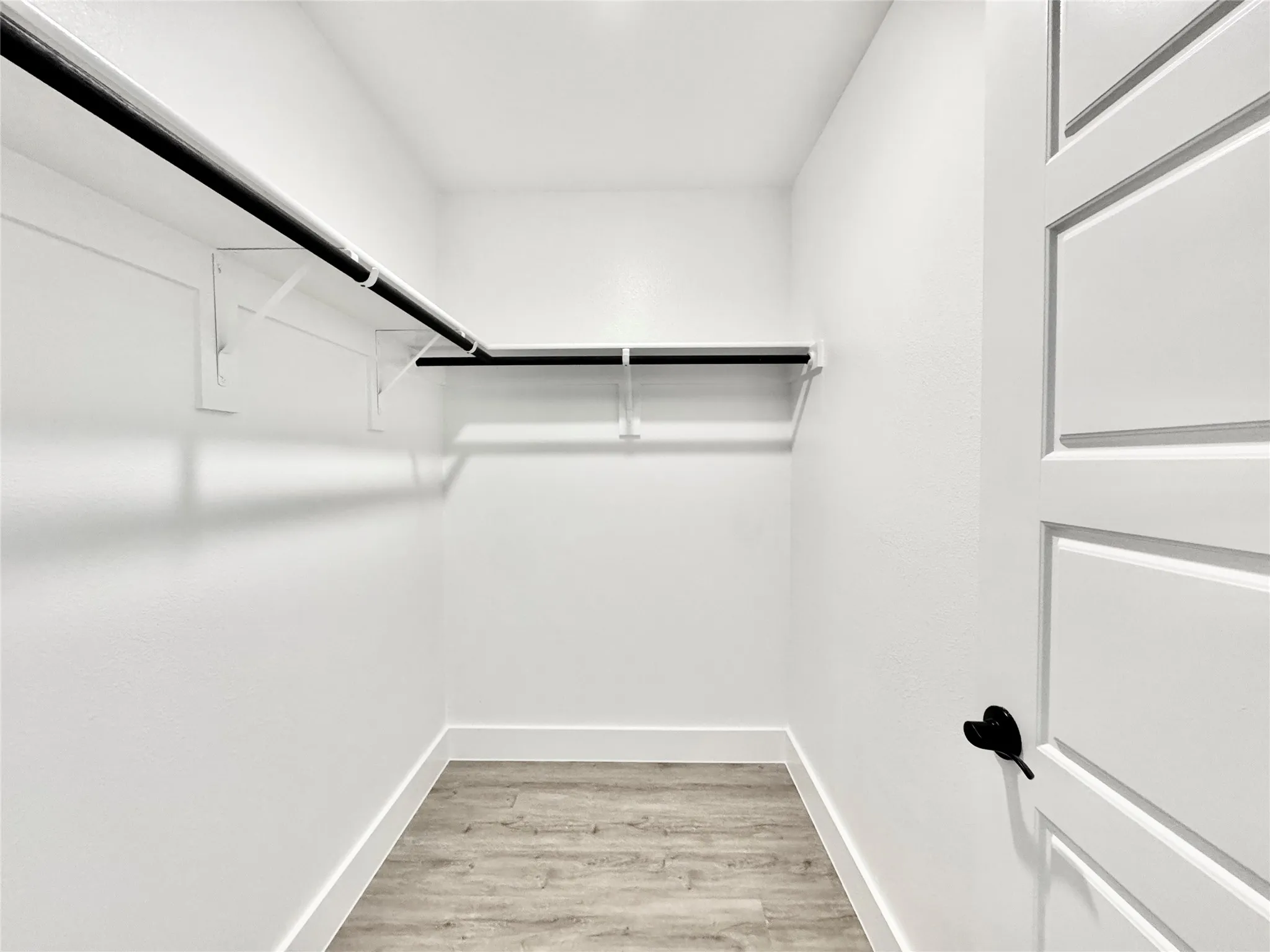 Walk in closet featuring light wood-type flooring
