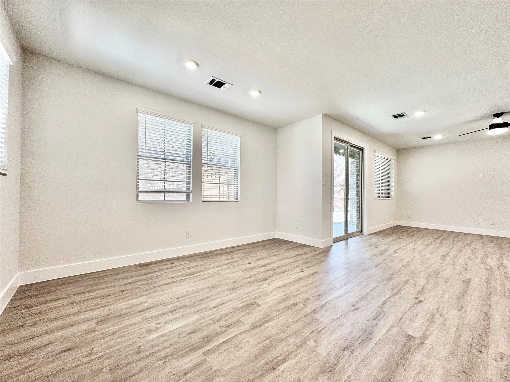 Spare room featuring light wood-style flooring, baseboards, recessed lighting, and a ceiling fan