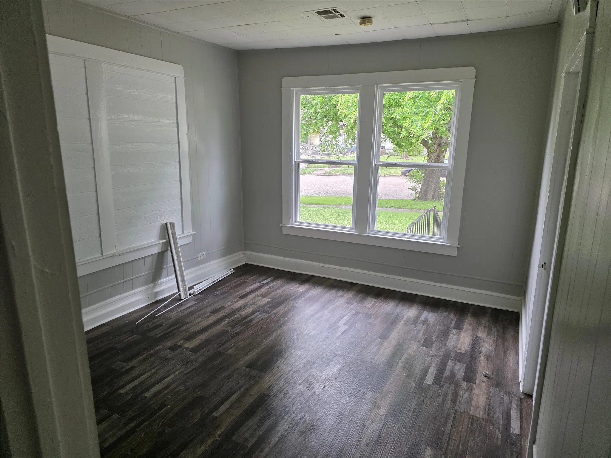 This room features dark-toned flooring, light gray walls, and white trim