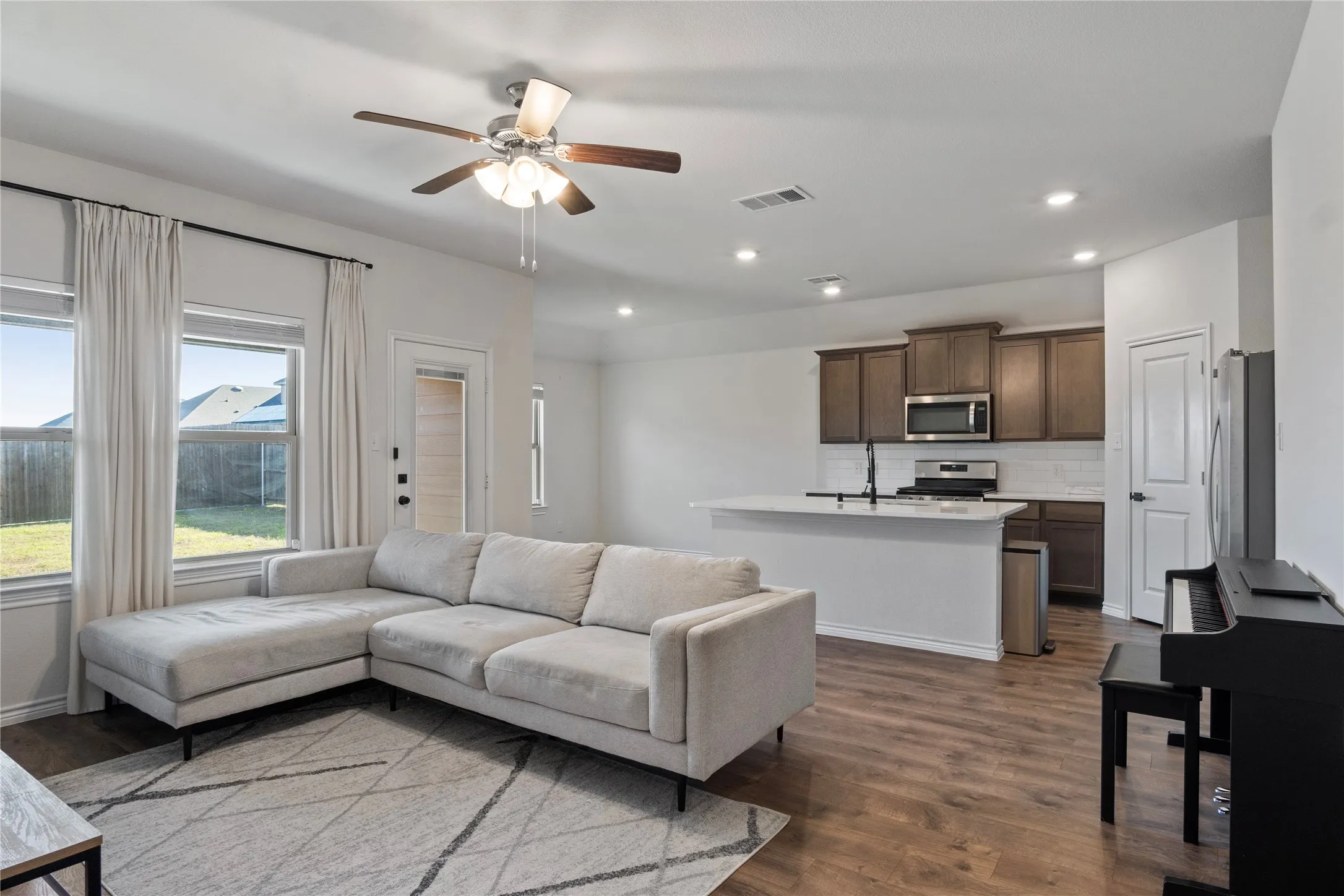 Open concept living space featuring wood-style flooring, recessed lighting, and a ceiling fan