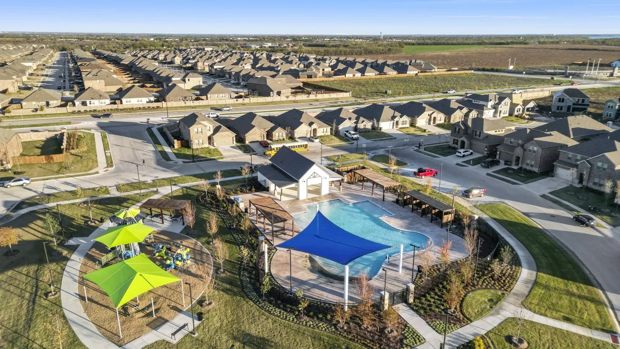Community amenities include a swimming pool with covered seating areas, a playground with shaded structures, and landscaped green spaces