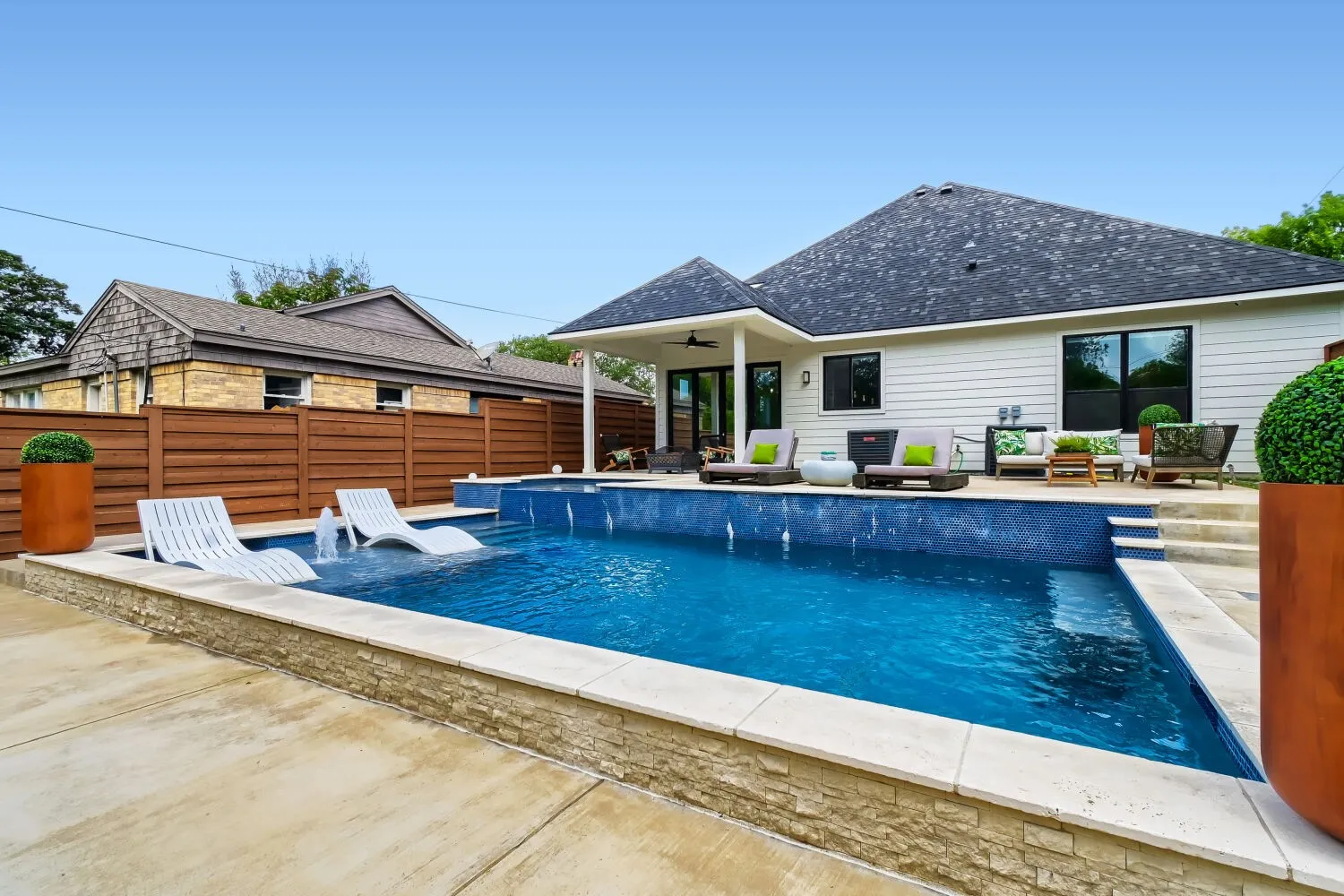 View of pool with patio surround, a fenced backyard, and an outdoor lounge area