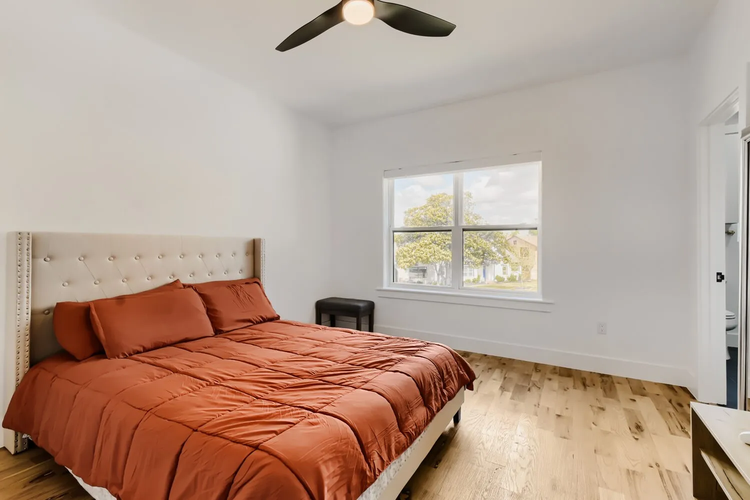 Bedroom with light wood finished floors and a ceiling fan